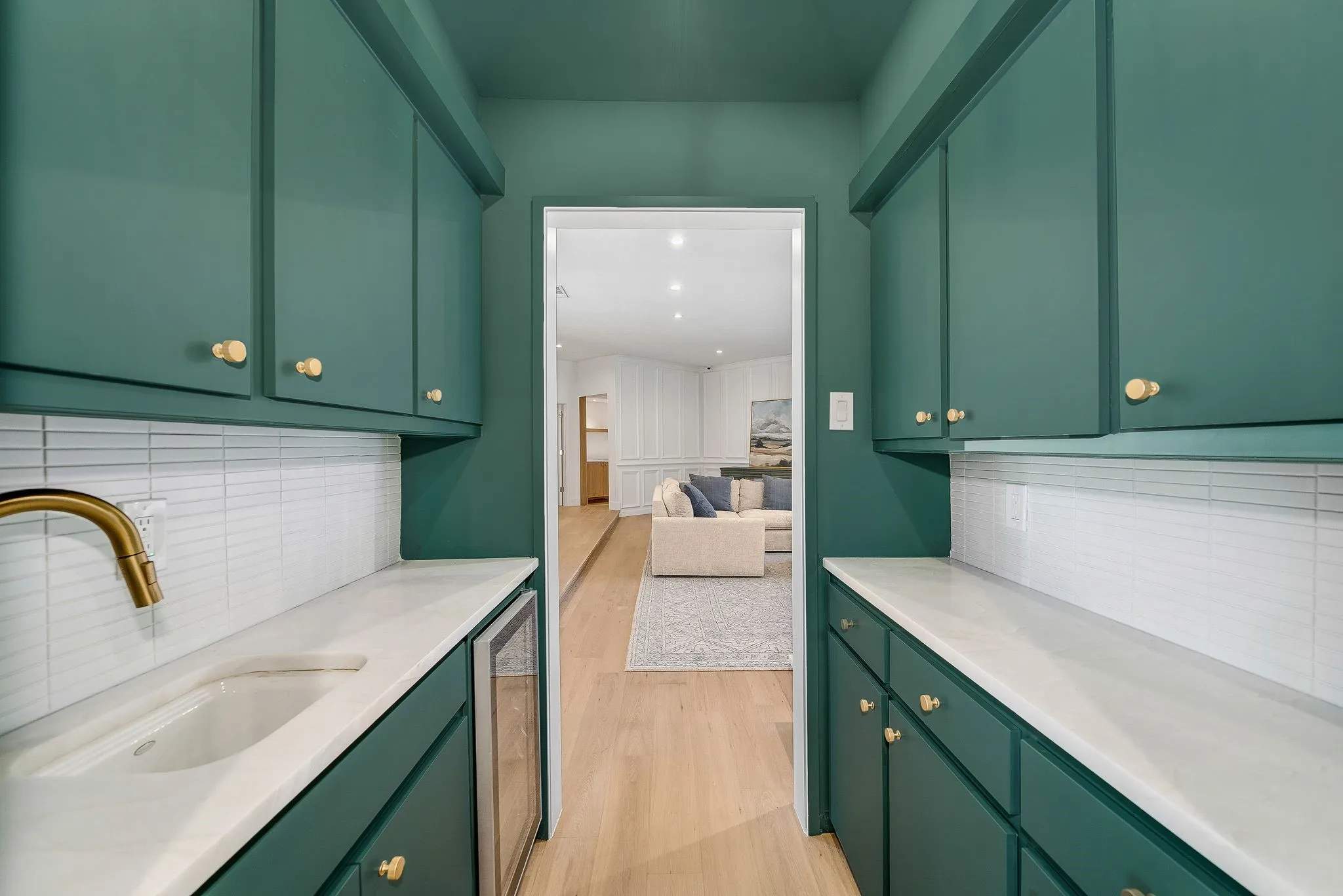 Bar with green cabinets, tasteful backsplash, and wine cooler