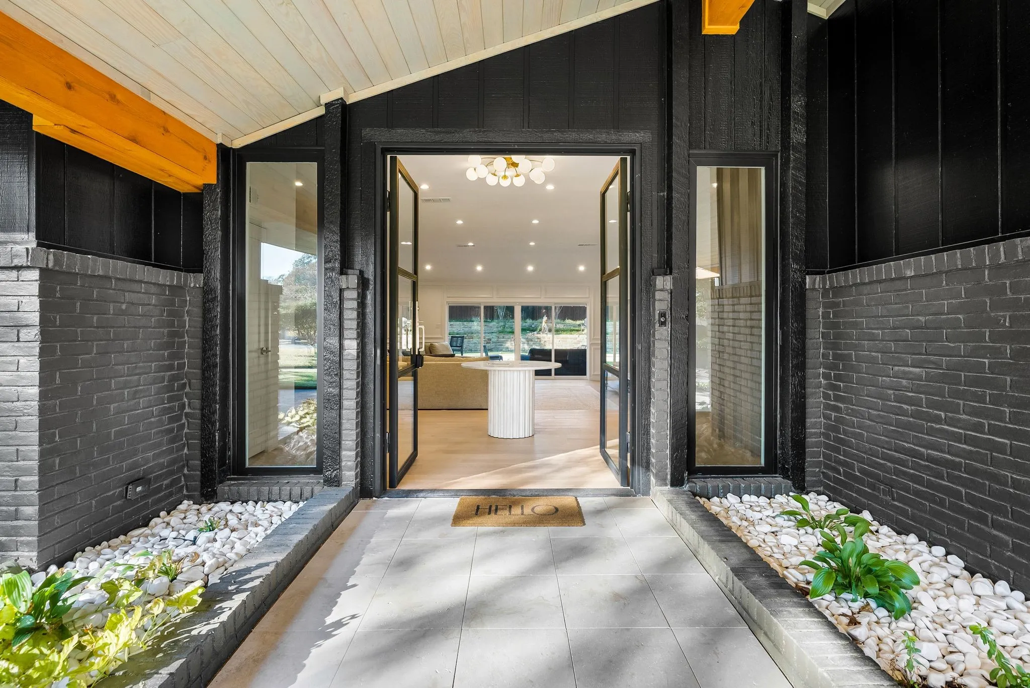 Doorway to property with brick siding and a patio area