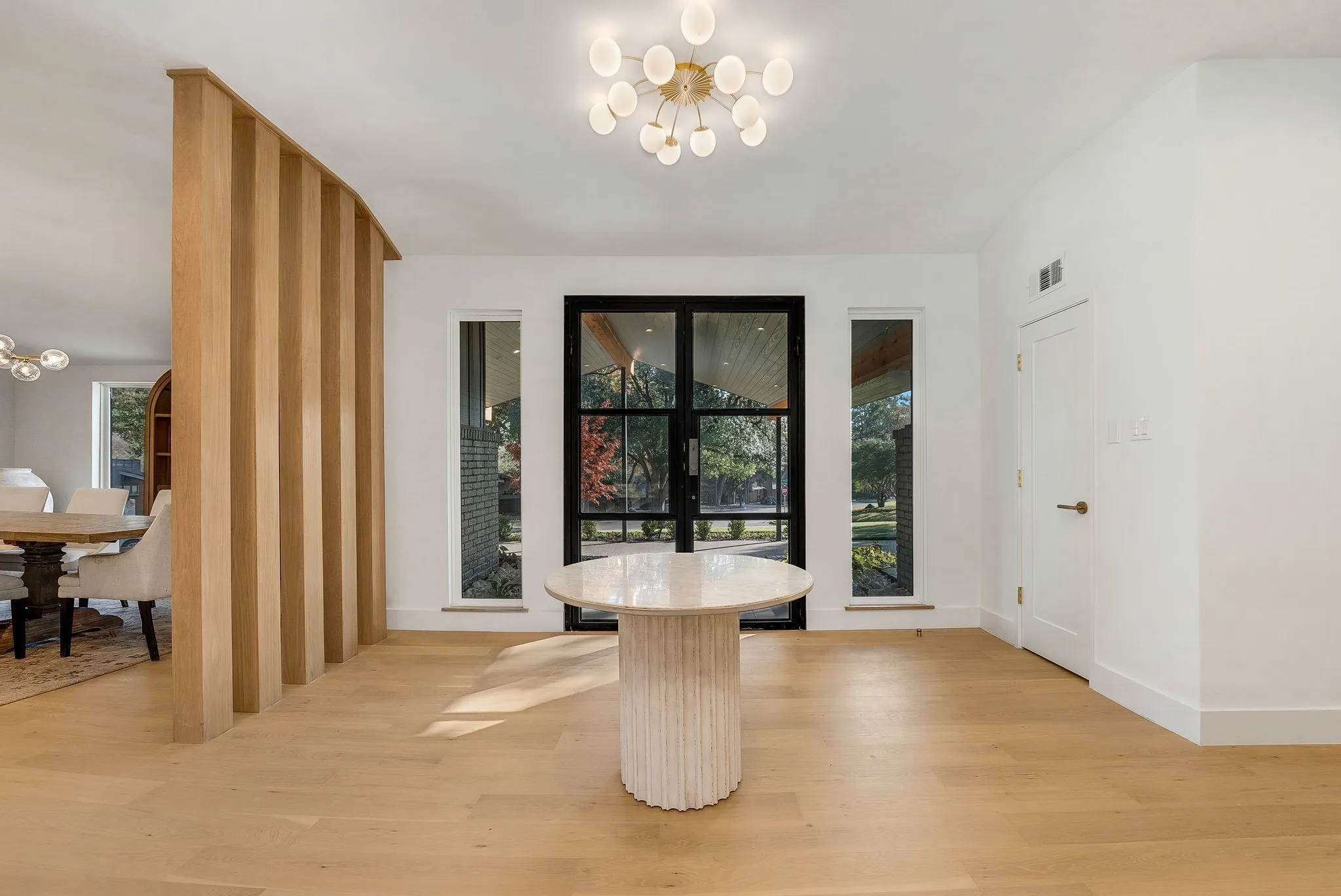 Dining area featuring a chandelier, light wood-style floors, and french doors