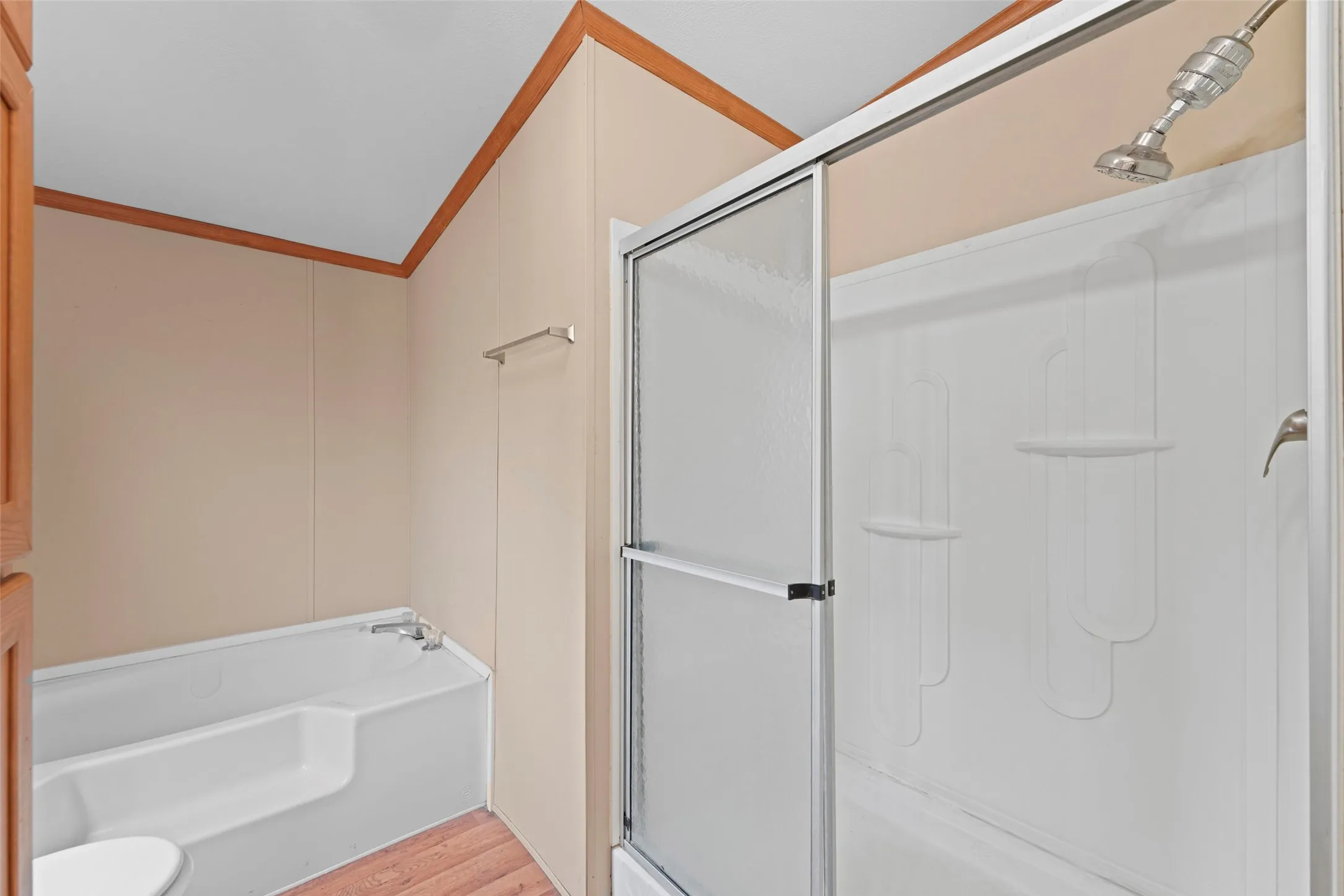 Bathroom featuring a shower with a sliding glass door and an attached bathtub with integrated steps
