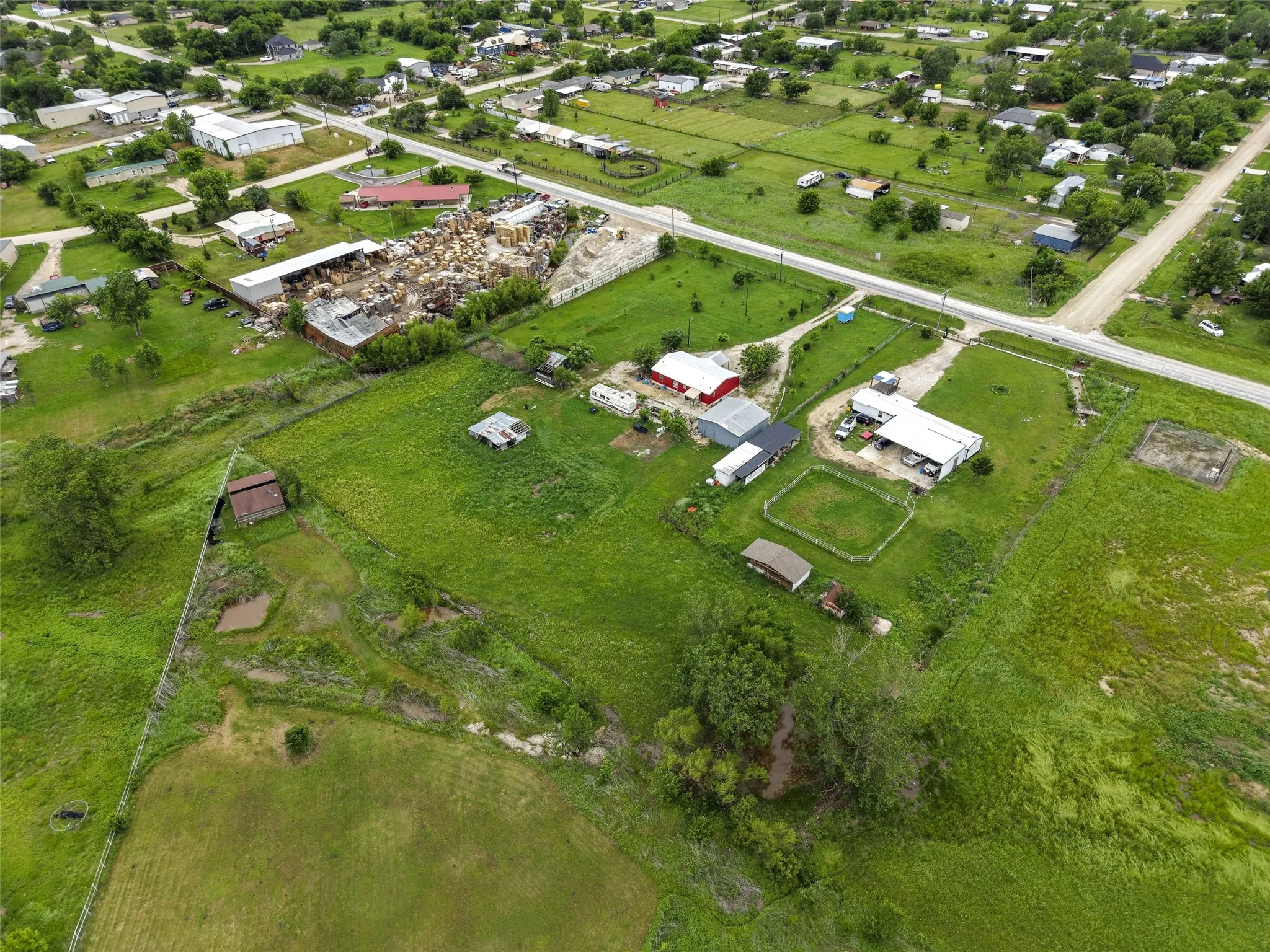 Expansive green landscape featuring multiple structures, including residential and utility buildings