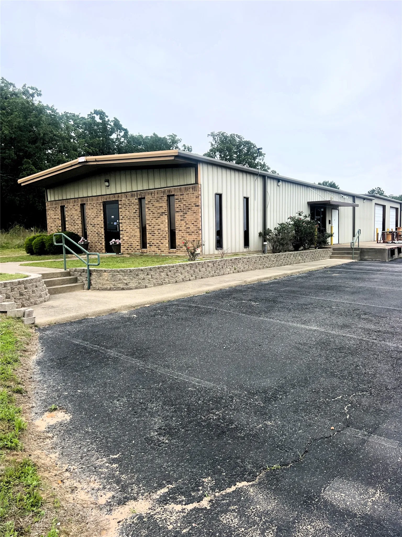 Commercial building featuring a brick facade and vertical metal siding