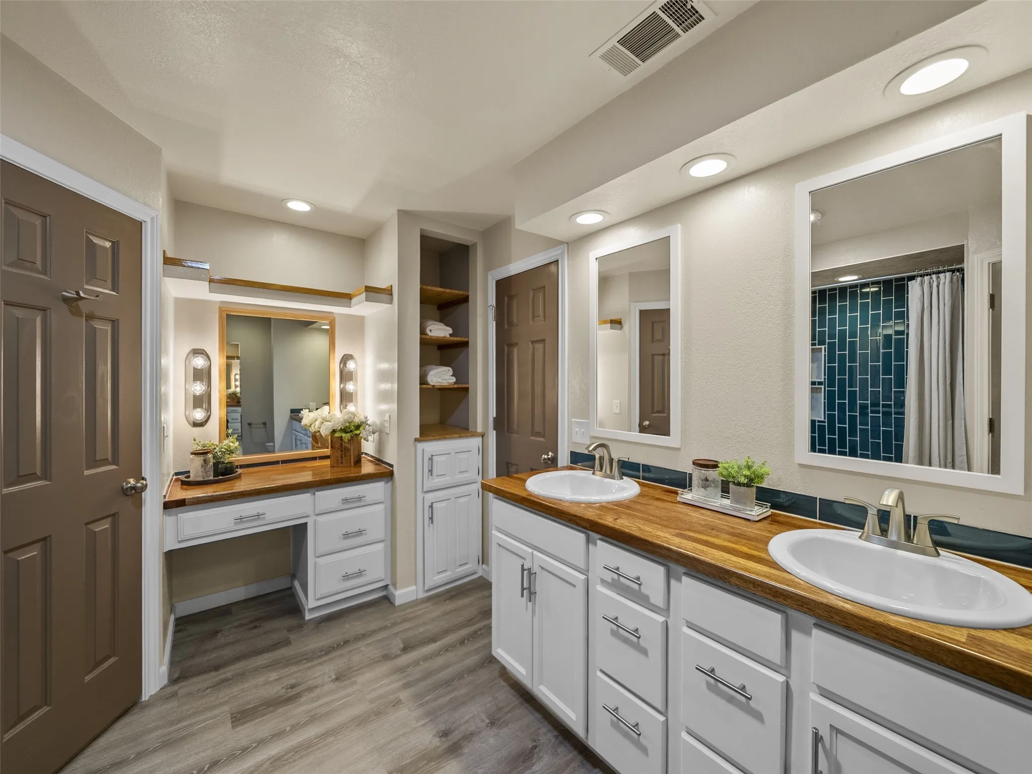 Master bath features a vanity space, and dual sinks.