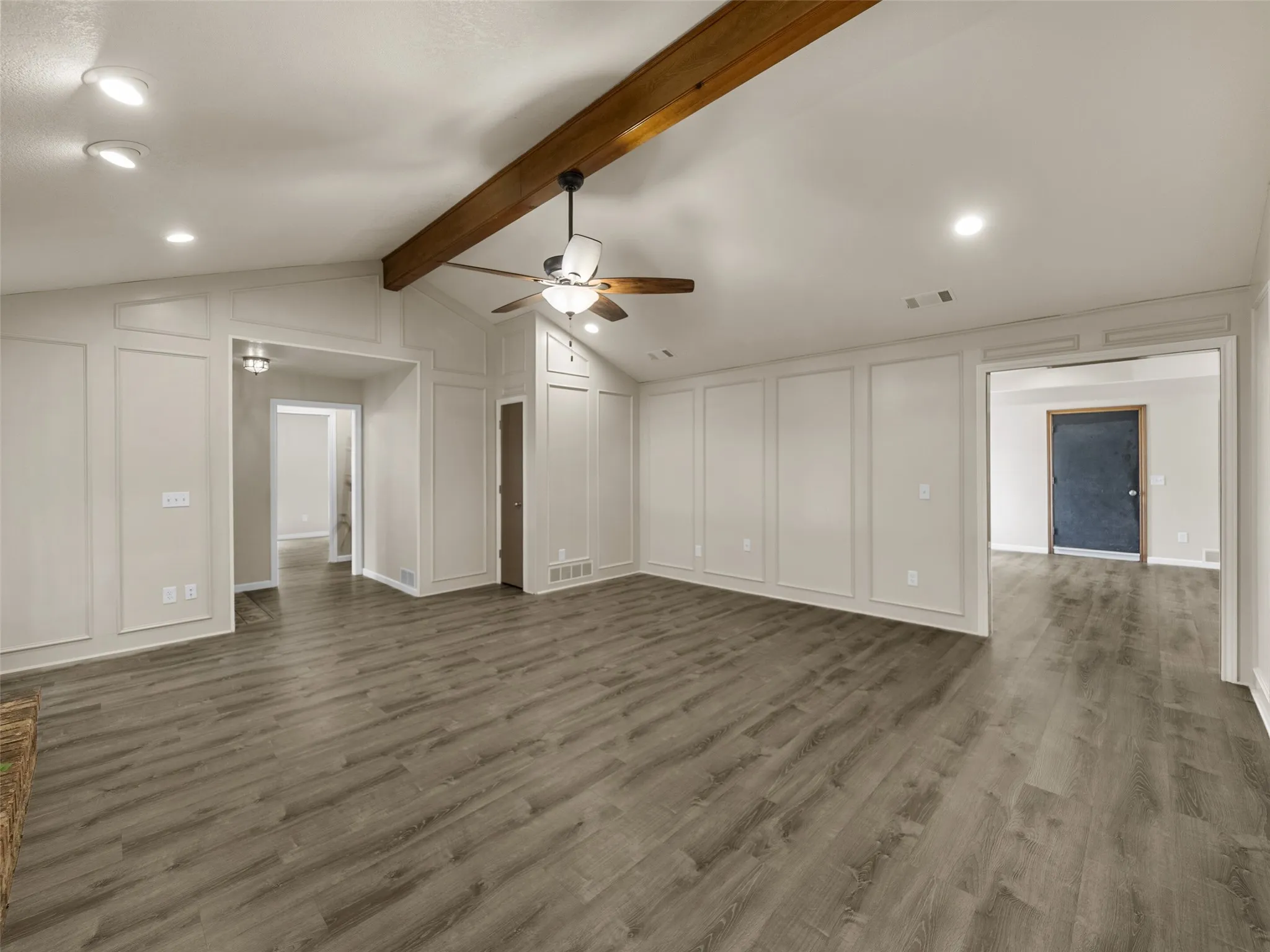 The Living Room opens to the game room beyond and leads in the other direction to the wing with the bedrooms.