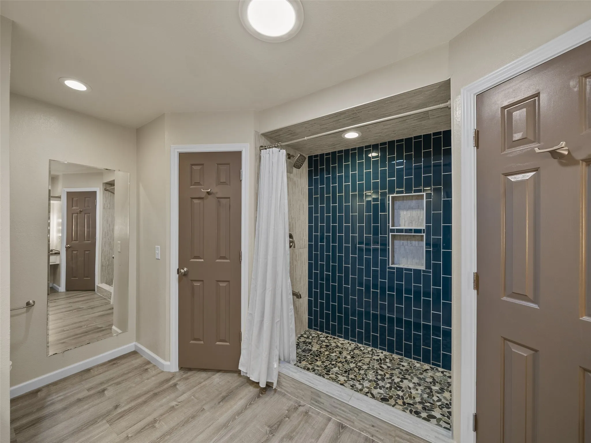 Dual walk-in closets with built-in drawers.  Above the separate commode area is additional shelving space.