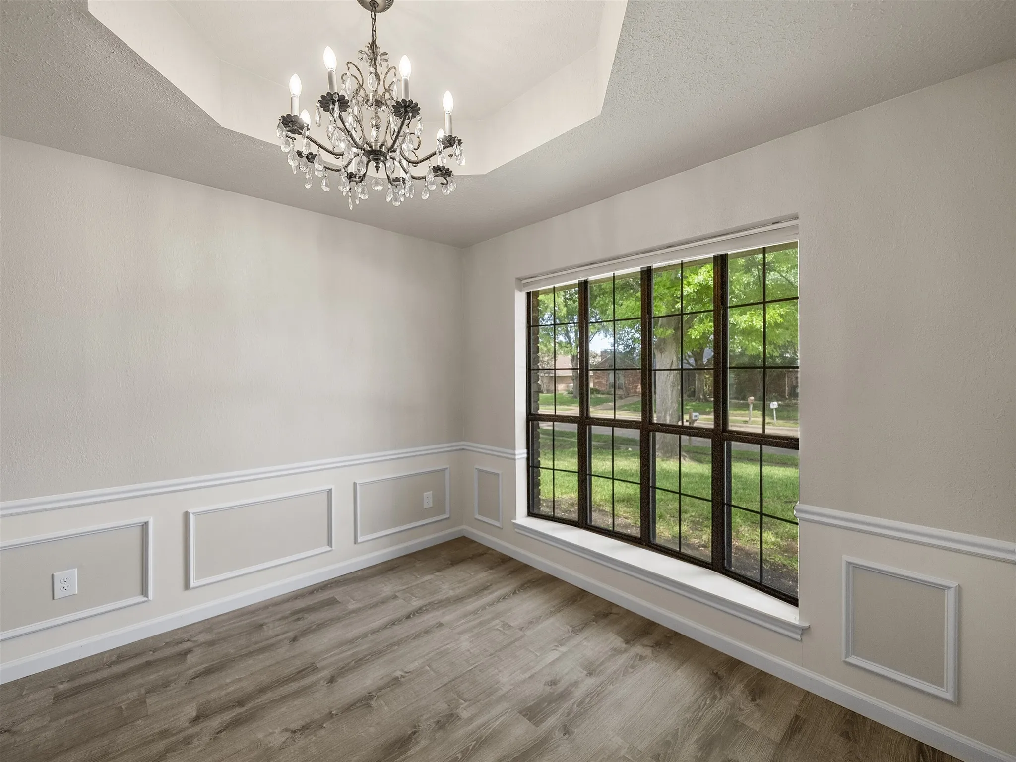 A box Ceiling and crystal chandelier enhance the formal dining space.