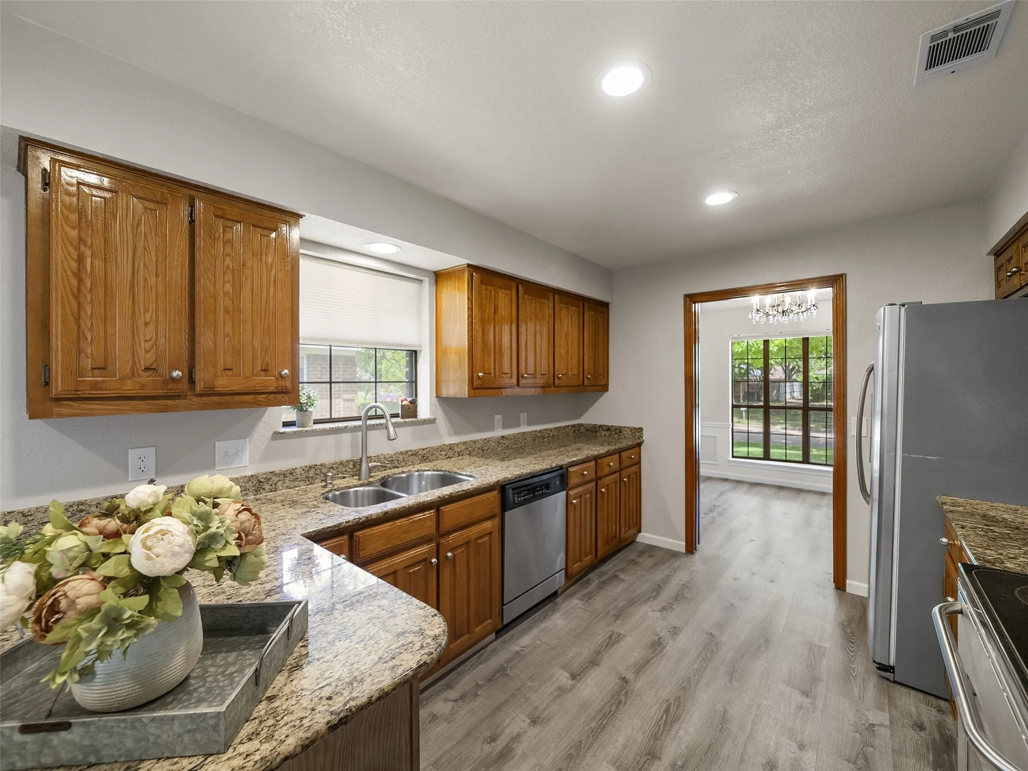 This charming kitchen has granite countertops and stainless steel appliances.