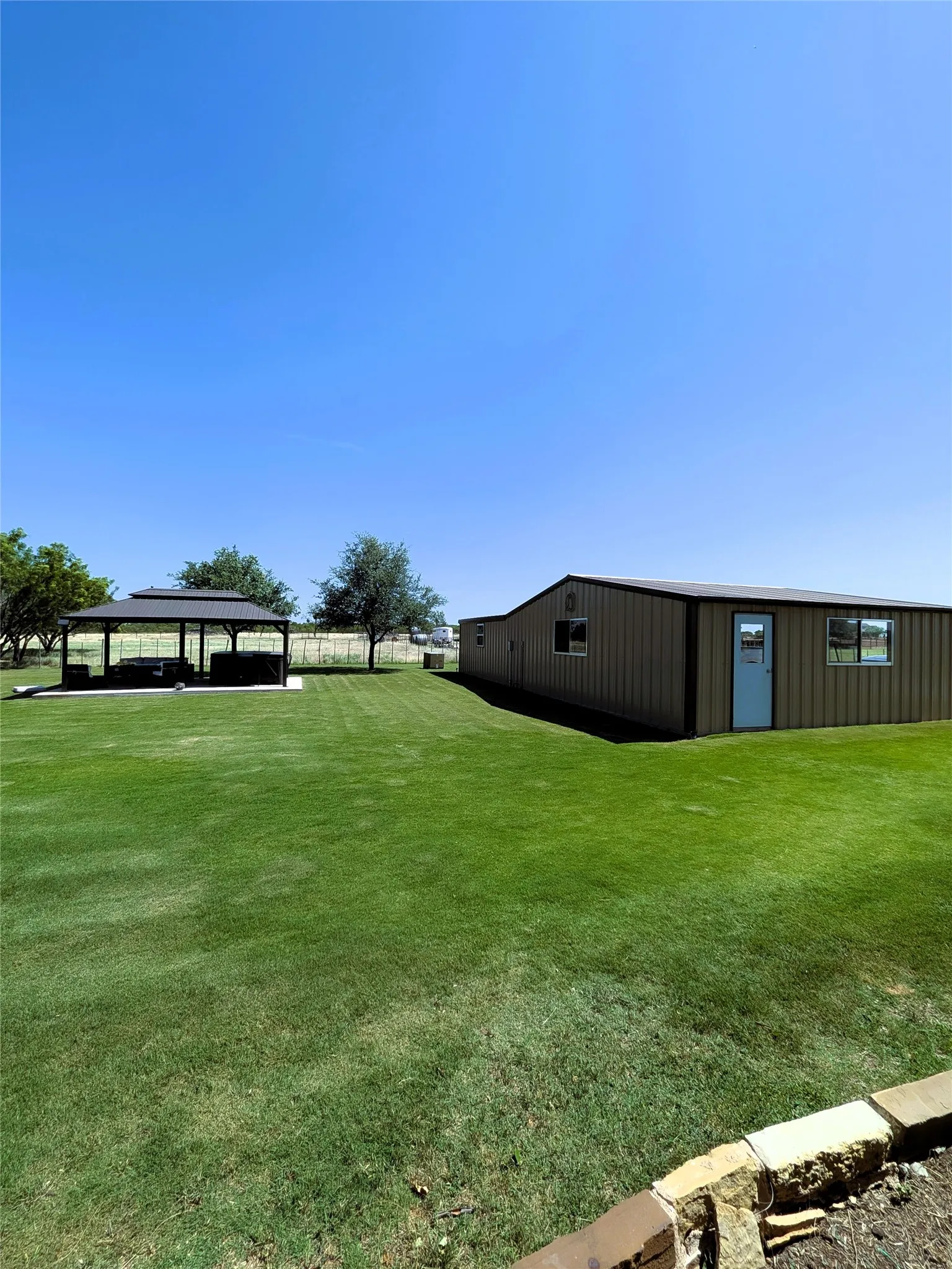 Backyard showing garage and shop
