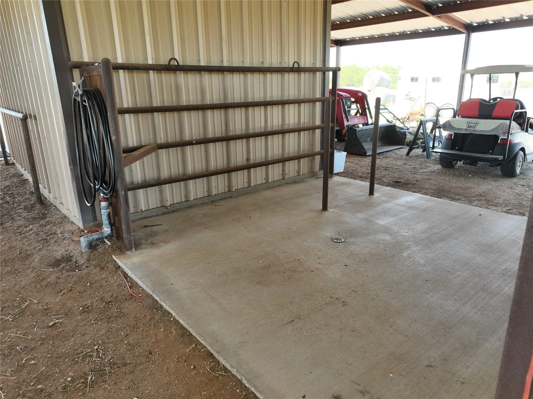 Wash Rack under the barn to the left of the alleyway across from the feed area. Attached is a 15' leanto that has an RV hookup.