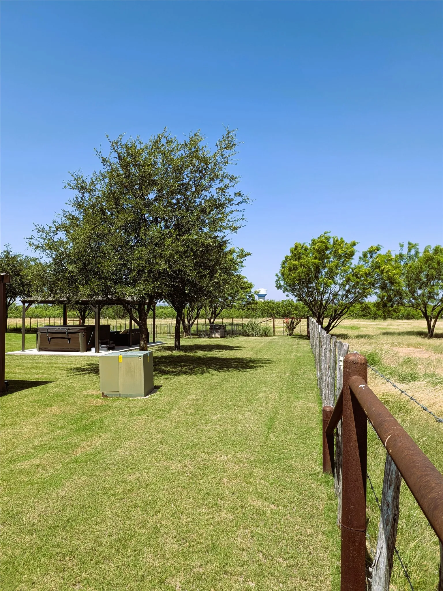 Showing beautiful trees and pergola plus field