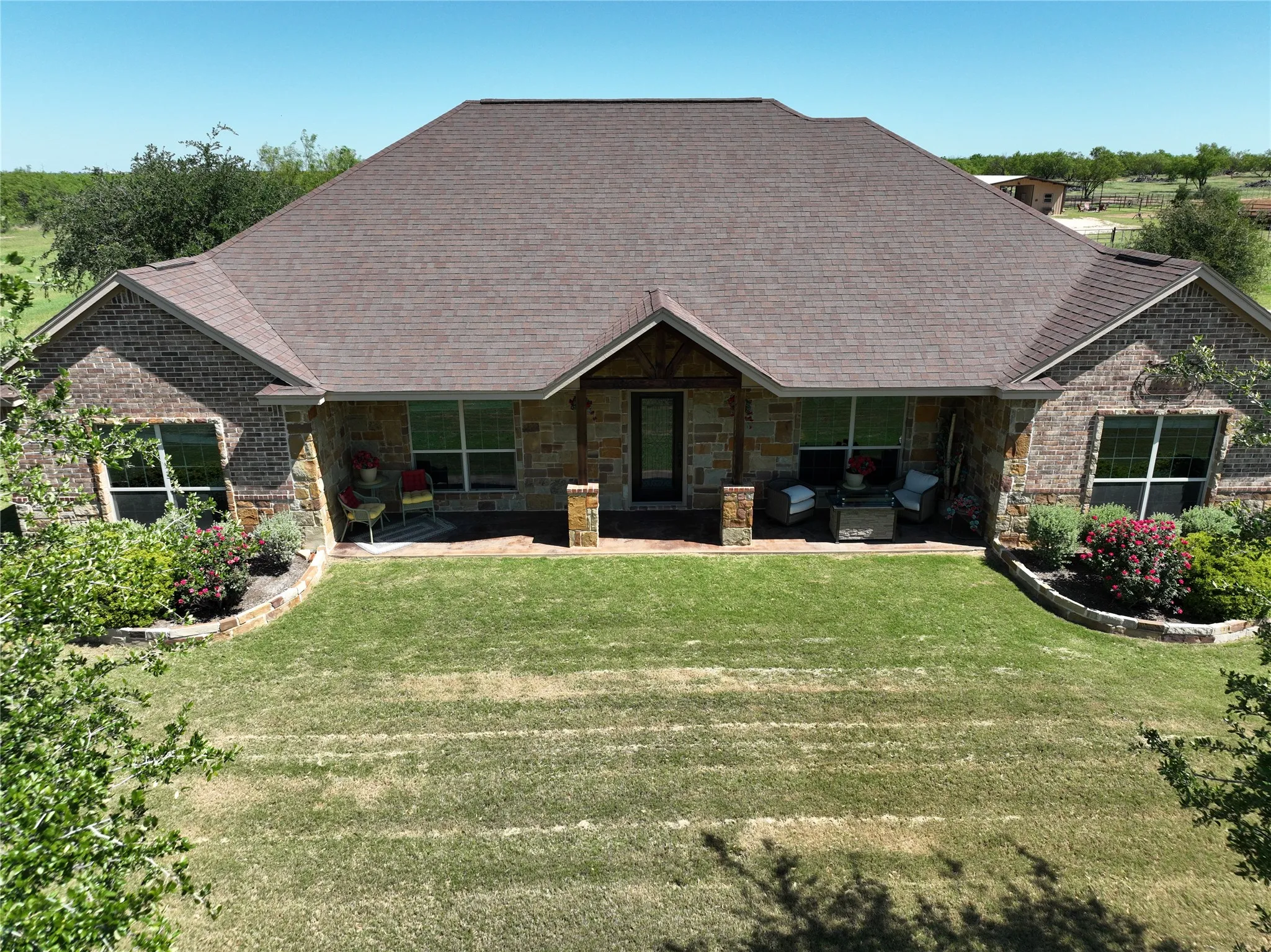 Landscaped front yard with an nice covered porch and beautiful entryway
