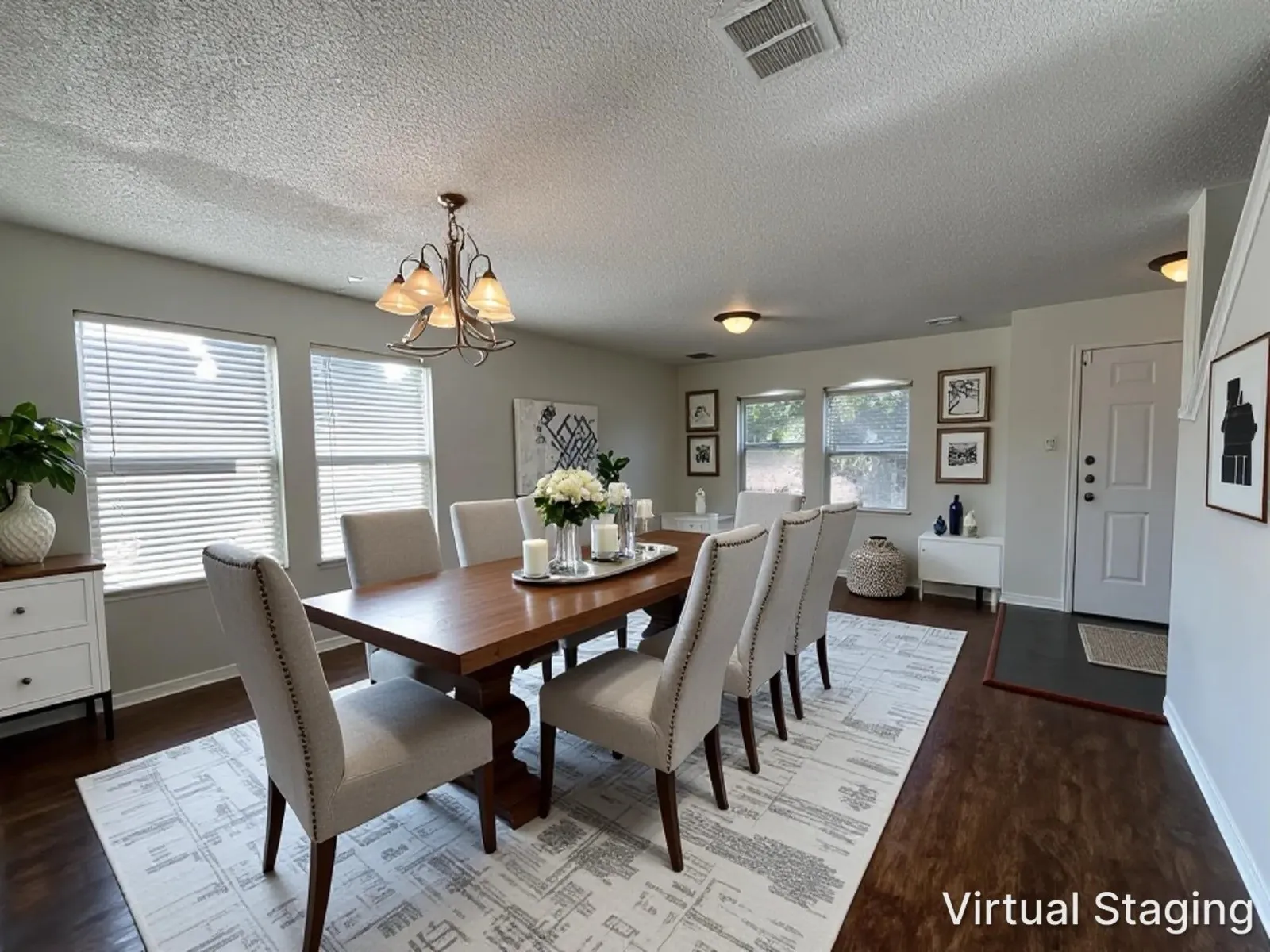 Open-concept living space with dark wood-finish flooring, multiple windows, and light gray wall paint