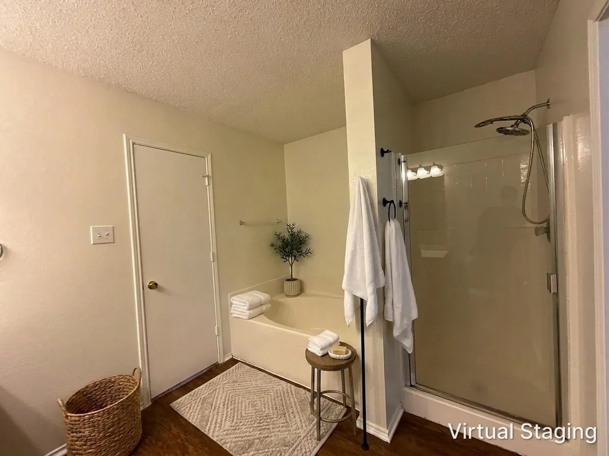 Bathroom featuring a built-in tub, a separate shower with a glass enclosure, and wood-finish flooring