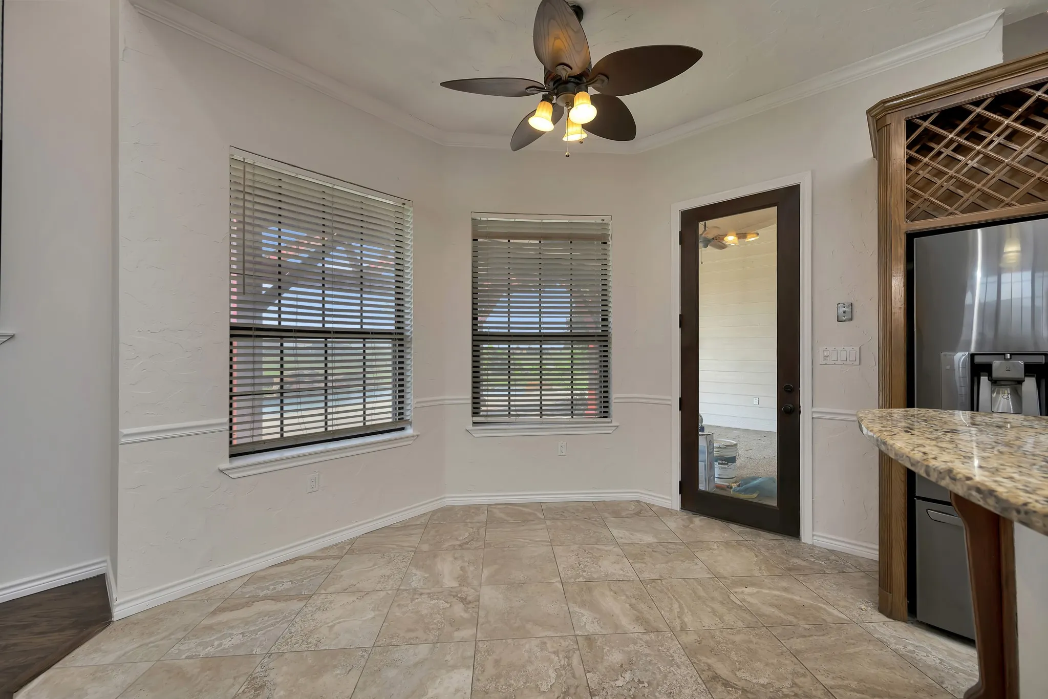Unfurnished dining area with crown molding and ceiling fan