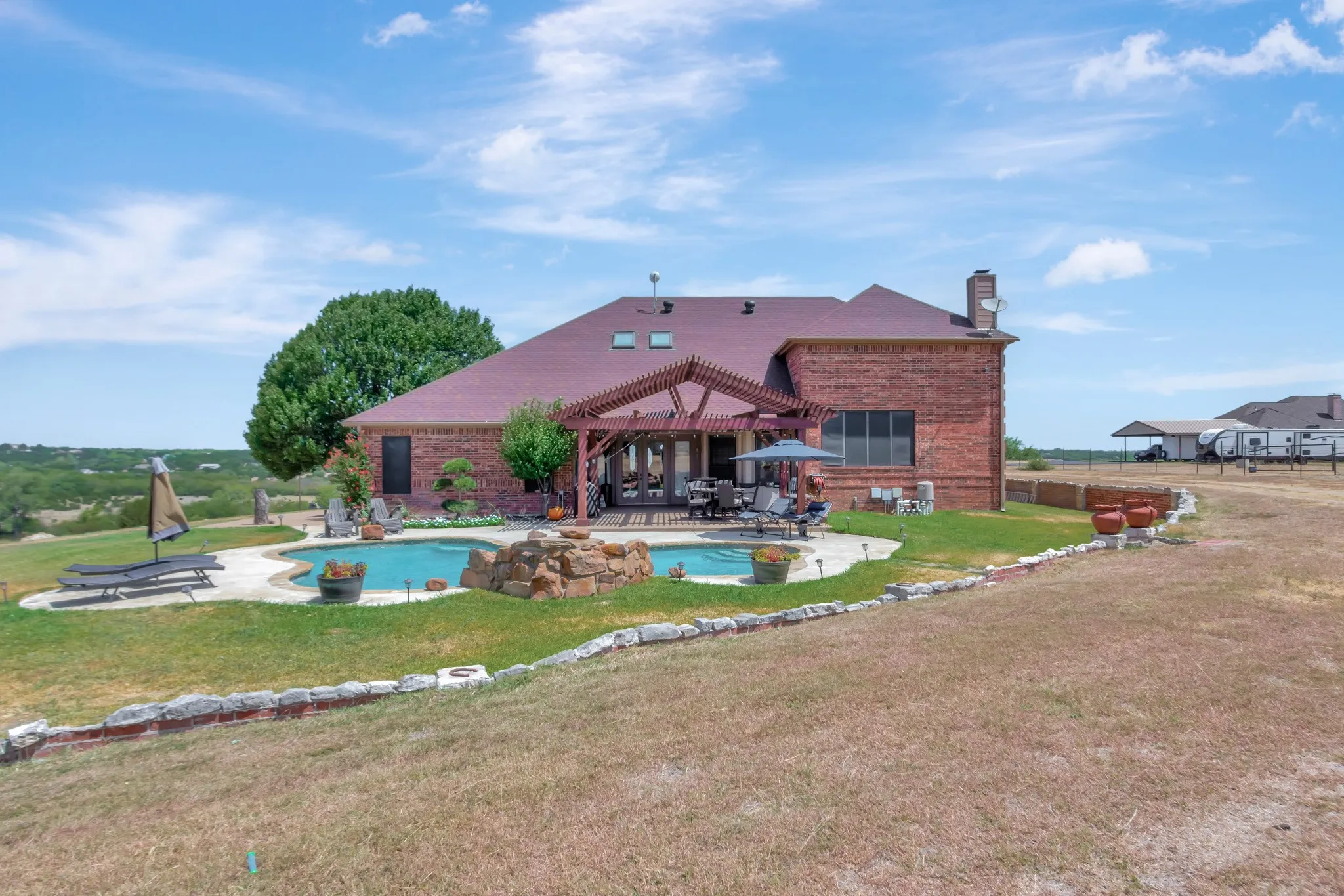 Swimming pool featuring a pergola, a patio area, and a yard