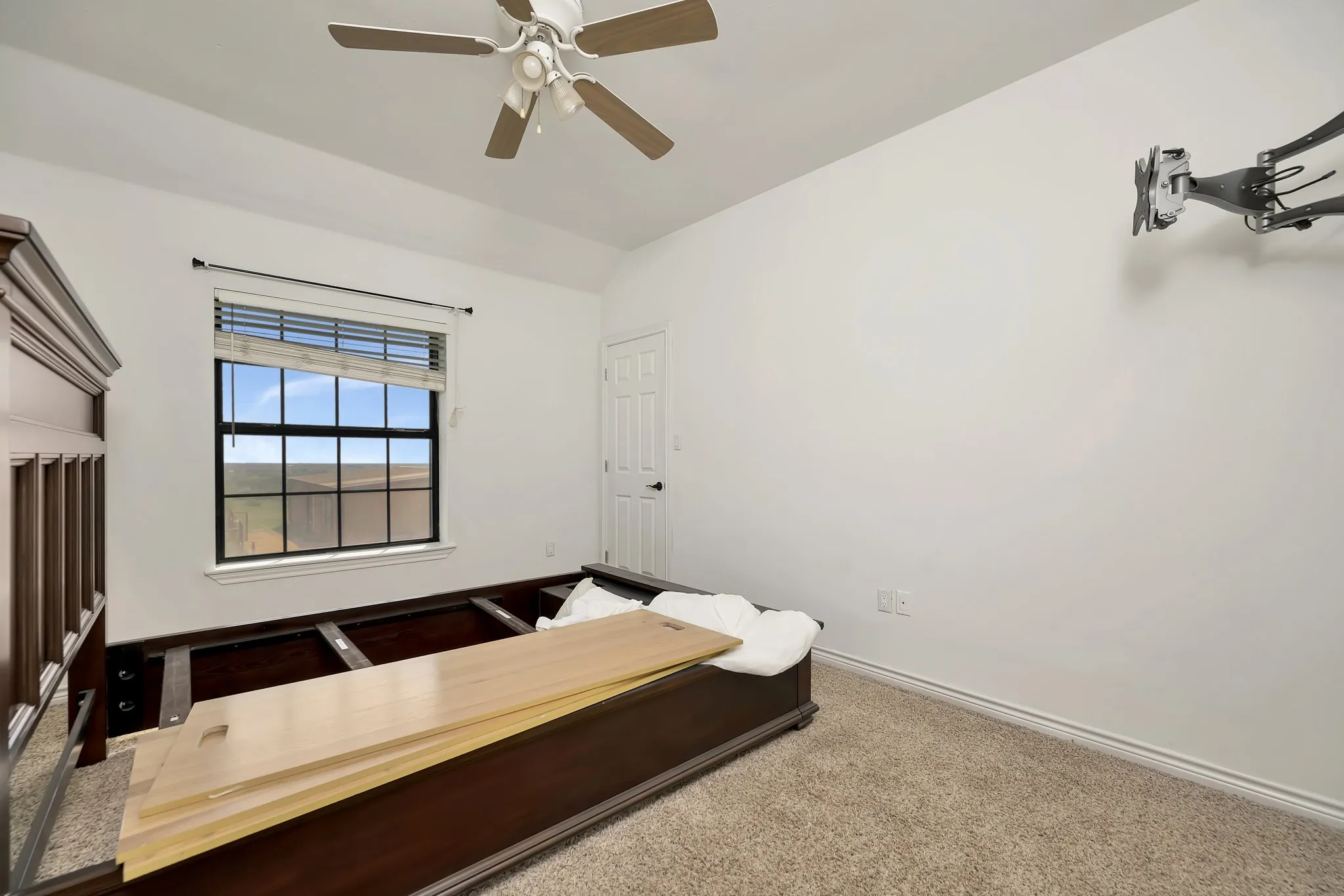 Bedroom featuring lofted ceiling, carpet floors, and a ceiling fan
