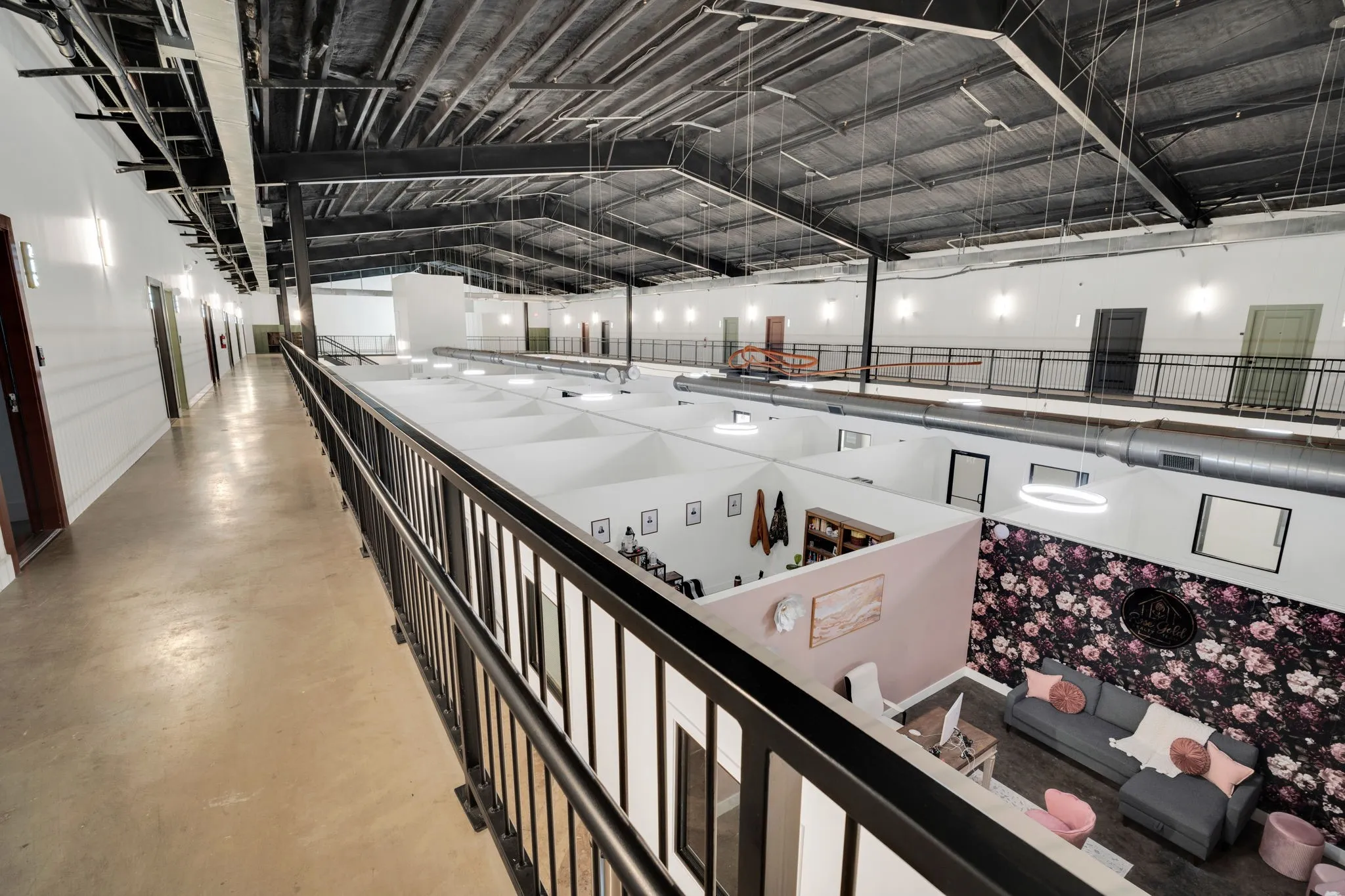 Spacious multi-level interior featuring concrete flooring and exposed structural beams