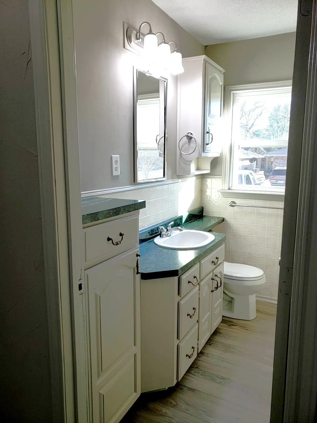 Full bathroom featuring a single vanity with an integrated sink, a built-in storage cabinet