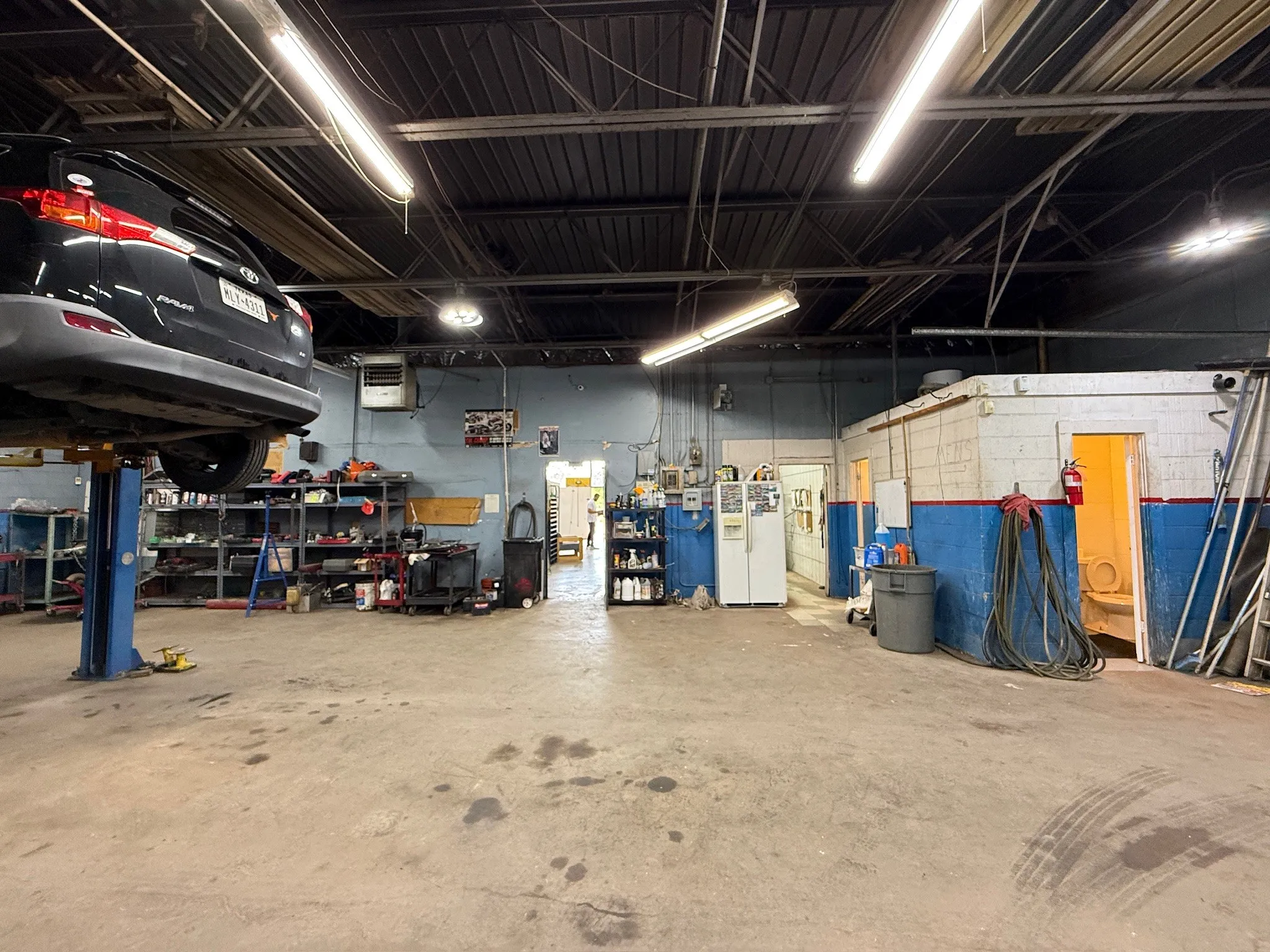 Industrial interior featuring concrete flooring and exposed ceiling beams