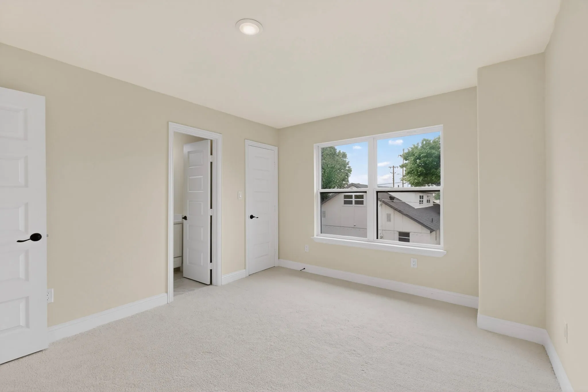 Carpeted room with neutral paint, recessed lighting, and white trim