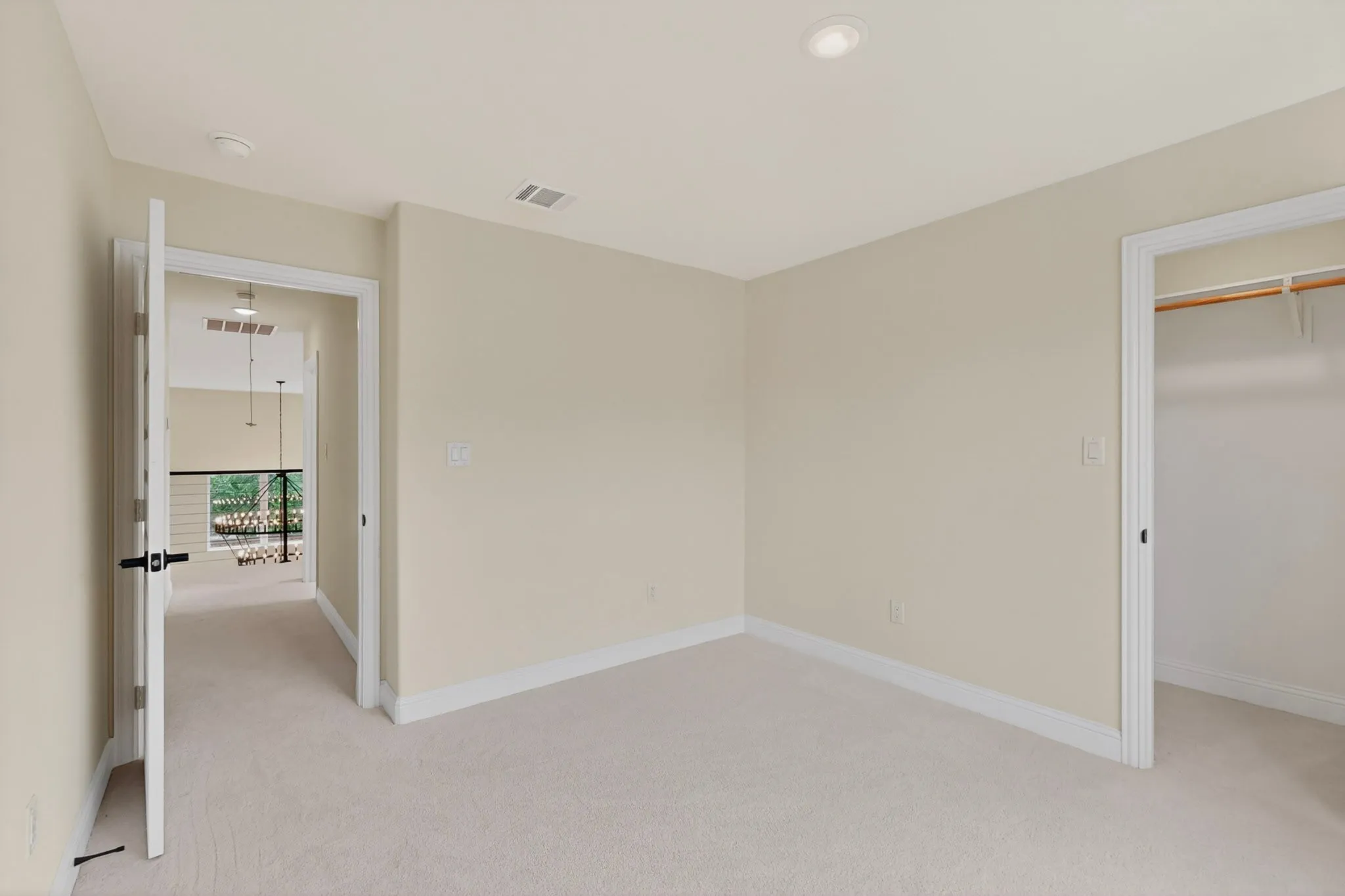 Carpeted room with recessed lighting and a walk-in closet featuring built-in shelving