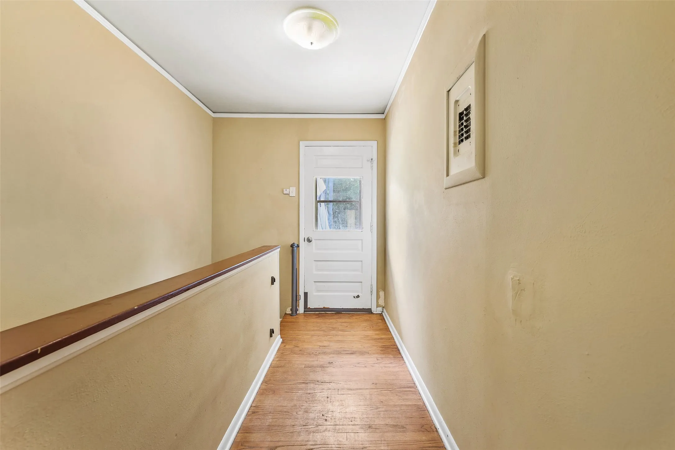 Hallway leading to basement stairs