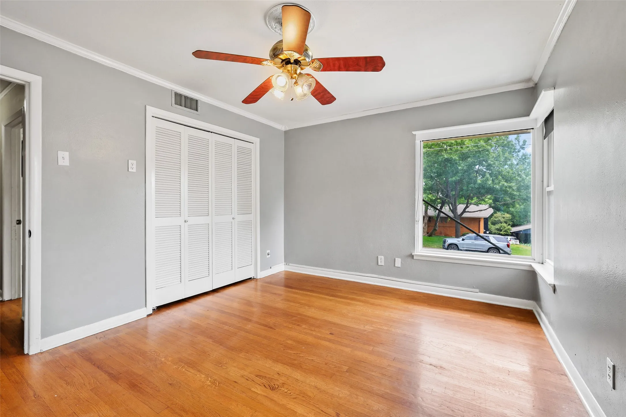 Large corner windows flood secondary bedroom with light