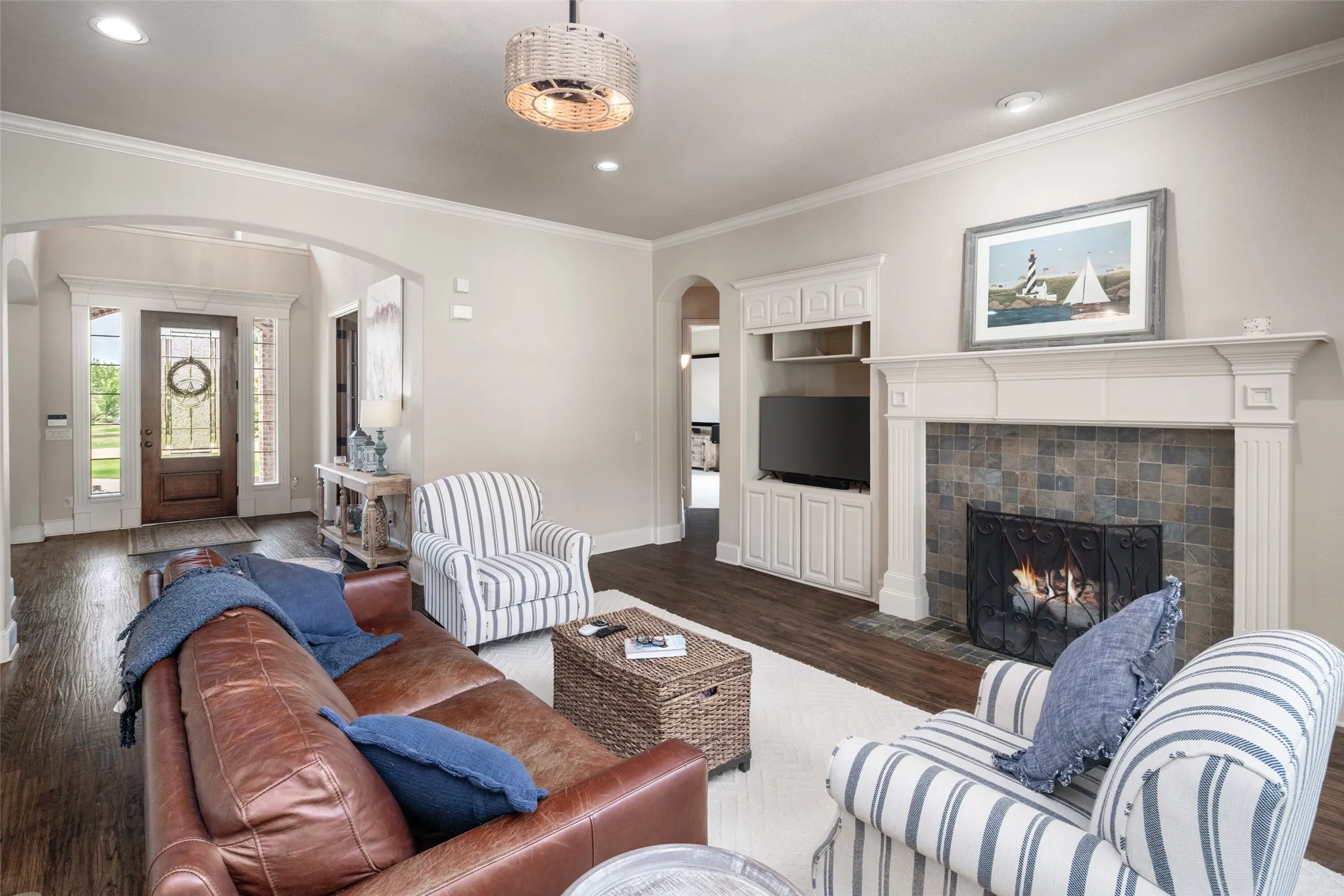 Cozy Fireplace with Decorative Mantle, Built in Cabinetry, Recessed Lighting, and Neutral Color Palette Throuought