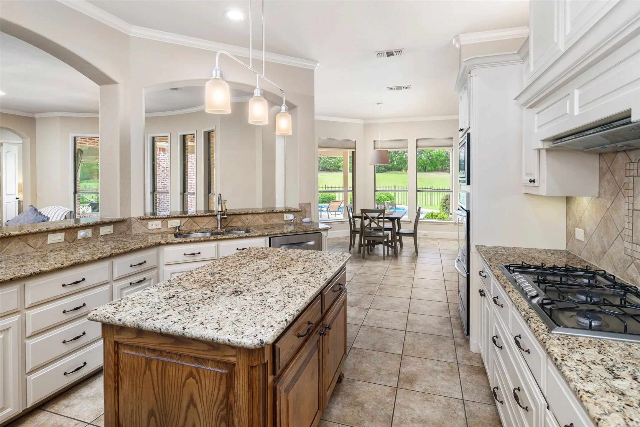 TONS of Cabinetry, Storage, and Countertop Space in the Beautiful Kitchen with a subtle blend of wood and cream tons.