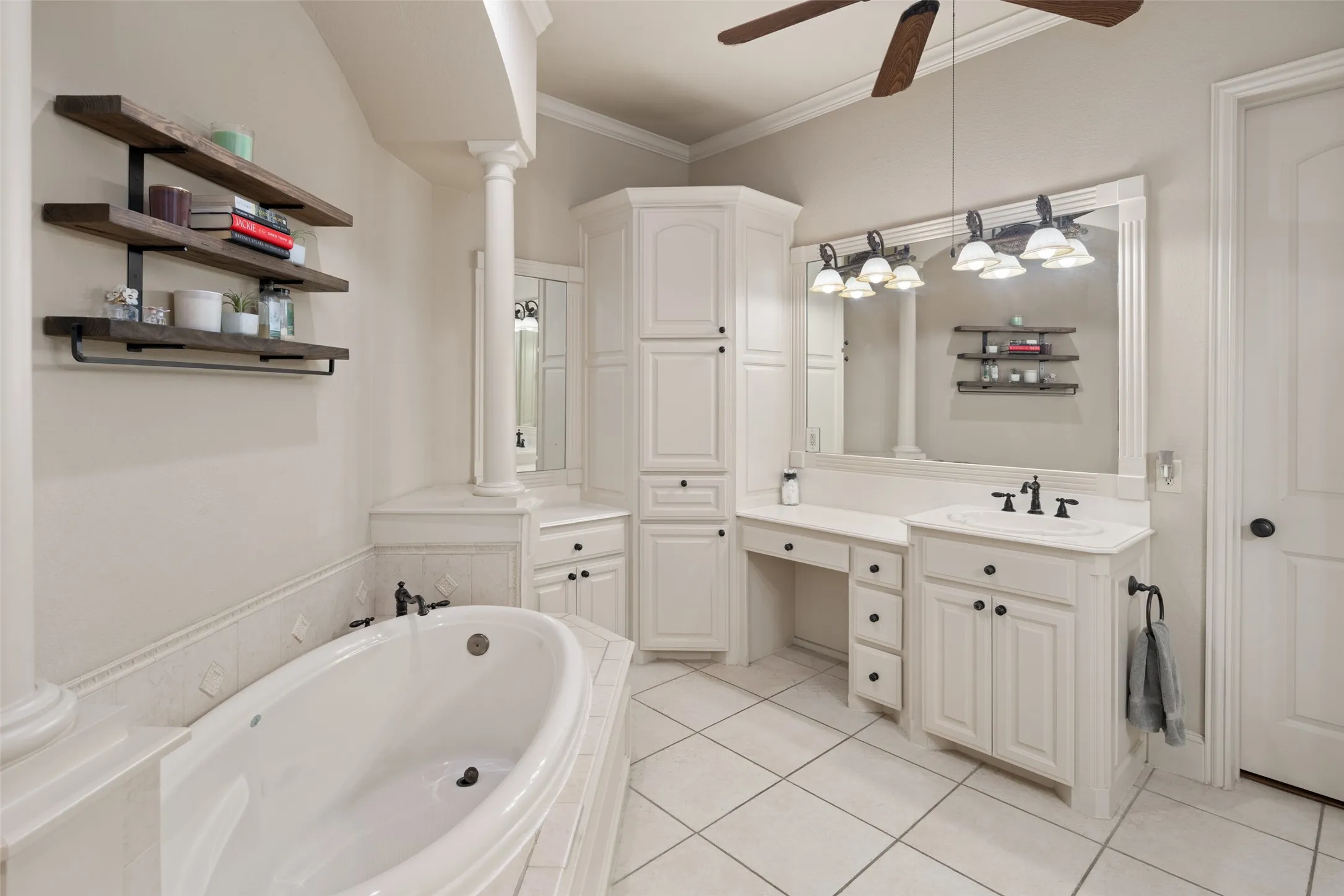 Lovely Primary Bath Offers Dual Sinks, Custom Built in Cabinetry, and Make Up Vanity. Decorative Lighting and Walk in Closet. Soak the Day away with a Good Book and Glass of Wine!