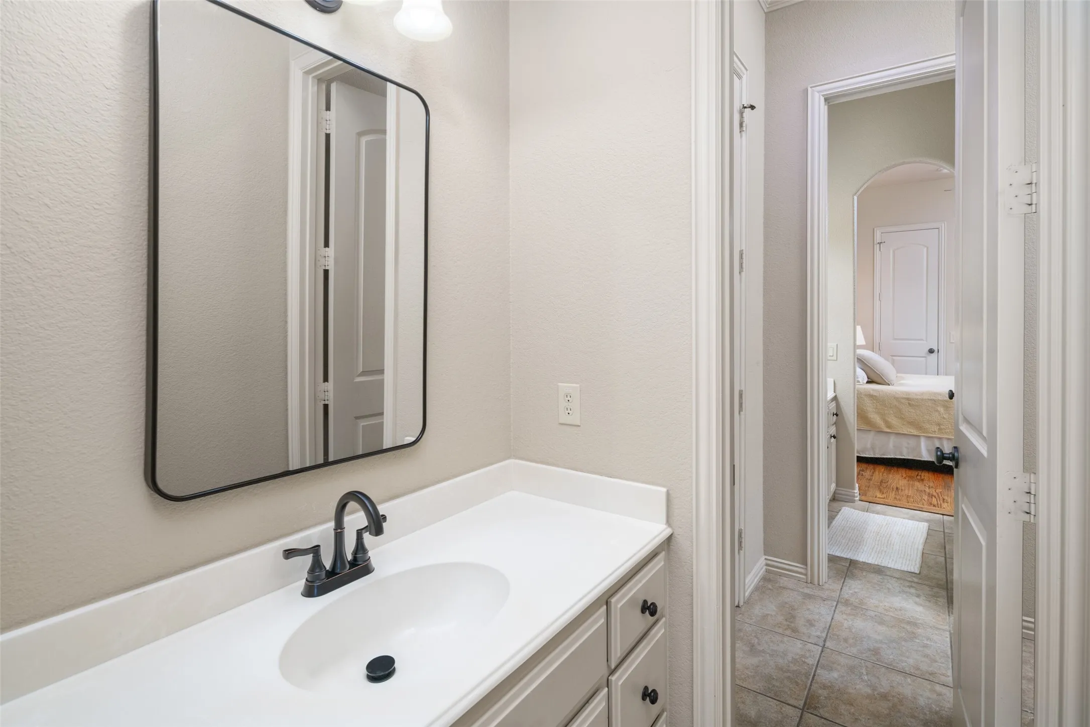 Jack and Jill Bathroom with Separate Sinks and Updated Mirrors.