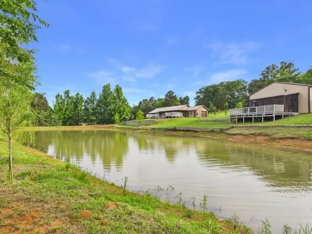 View over the willow lined pond, toward the main house