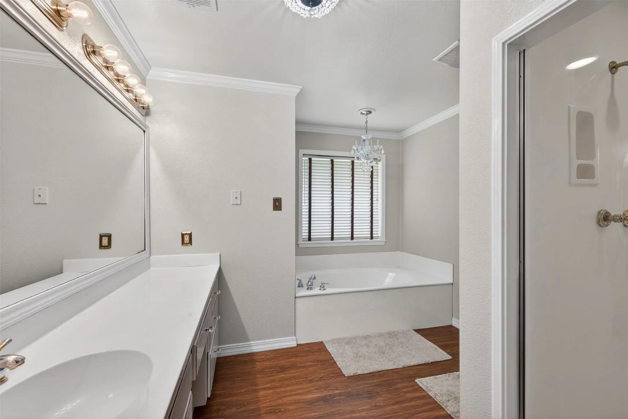 Bathroom featuring a double vanity with integrated sinks and a large mirror