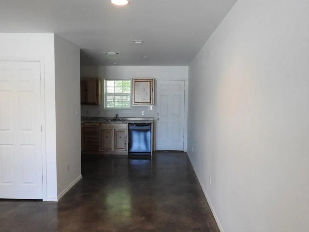 Open concept kitchen featuring recessed lighting, a window over the sink, and a dark finish dishwasher