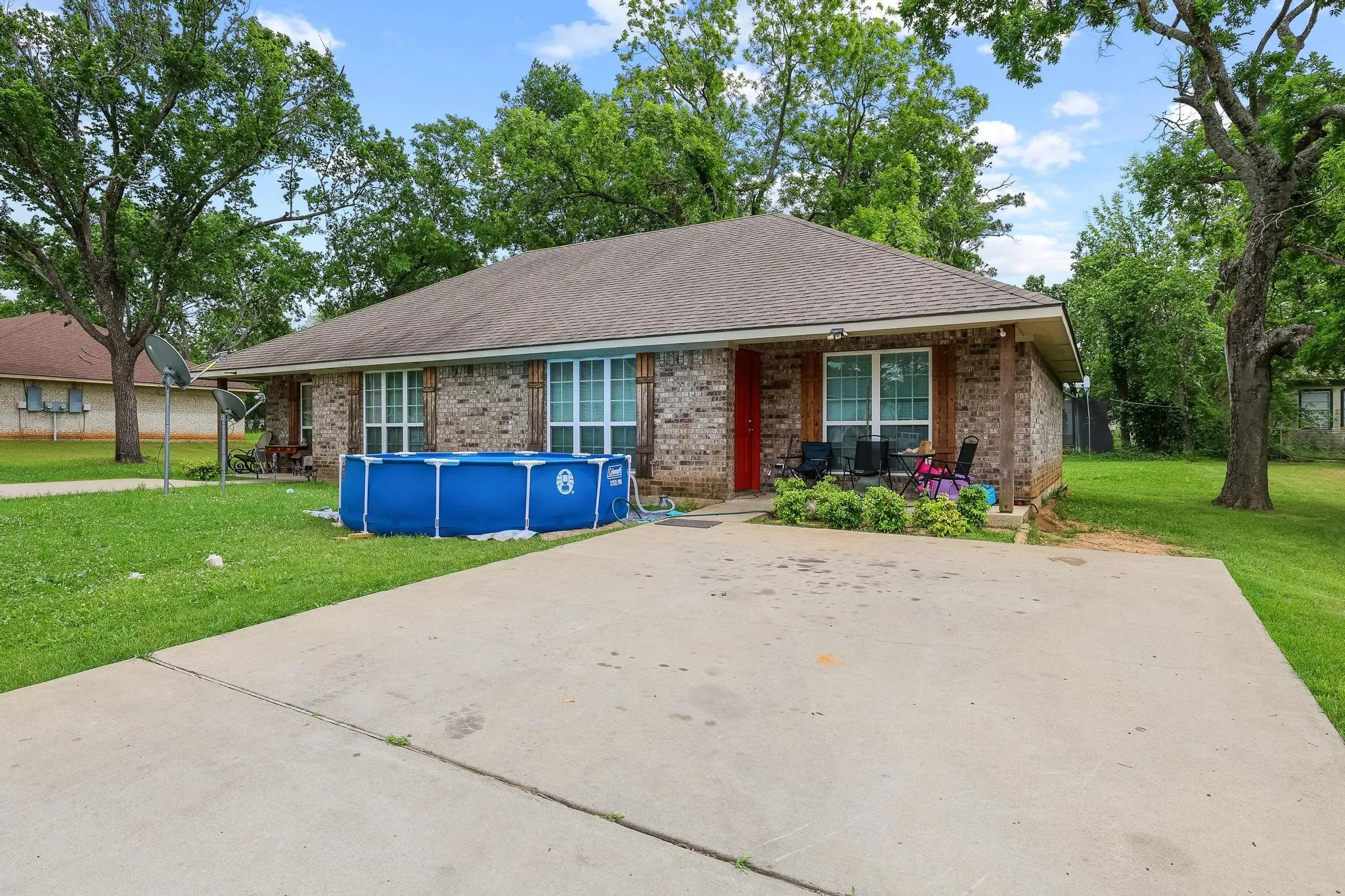 Brick facade home with a prominent red entry door