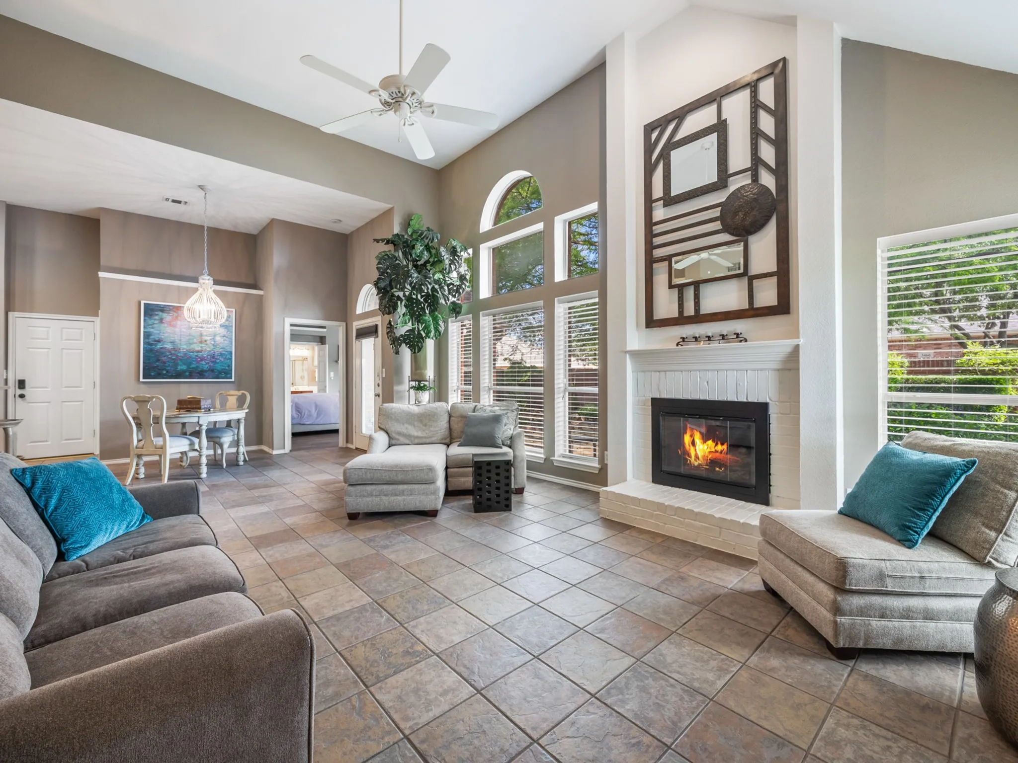 Expansive living area with vaulted ceilings and large format tile flooring