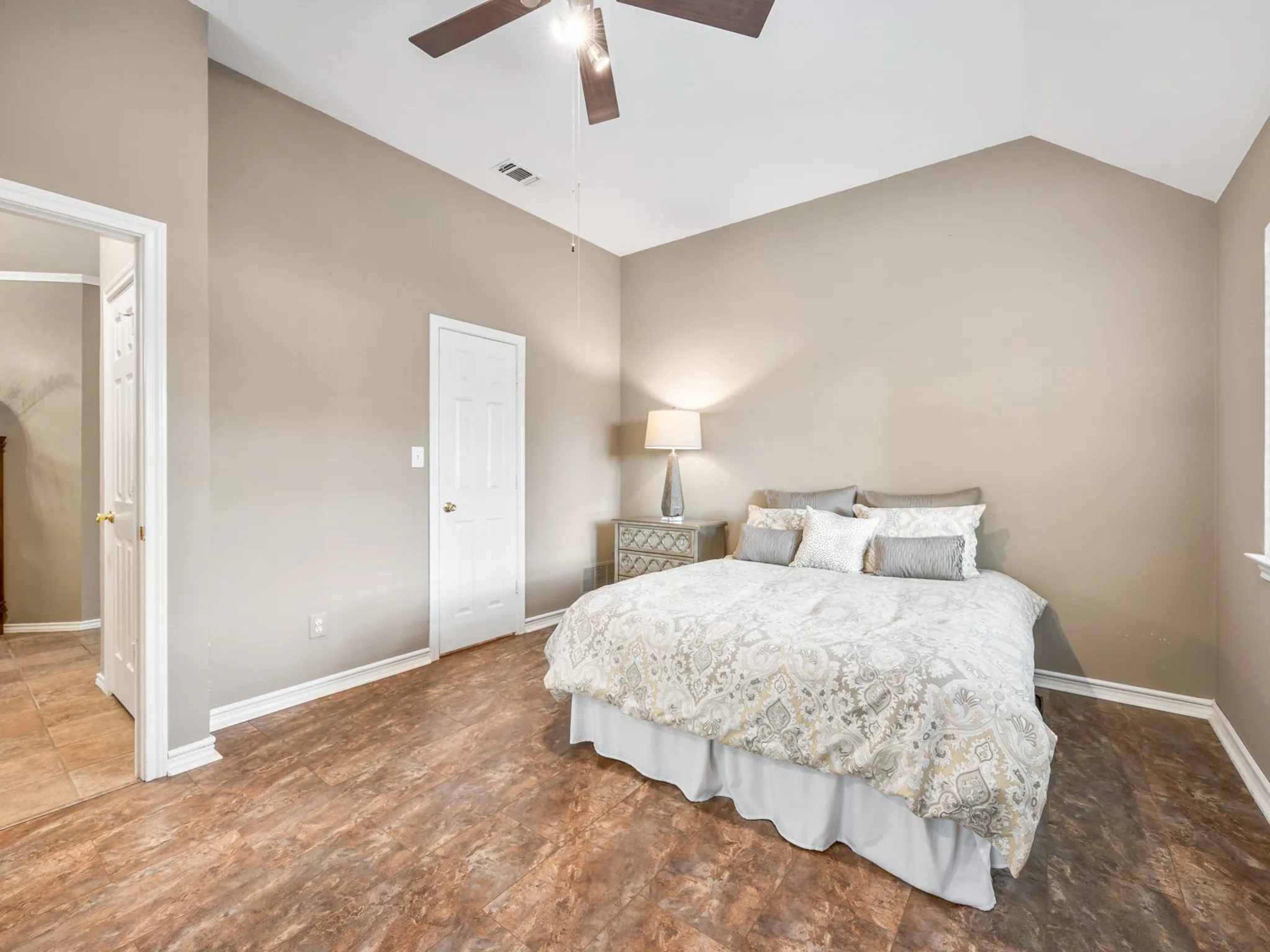 Room featuring wood-finish flooring, vaulted ceiling, and a ceiling fan