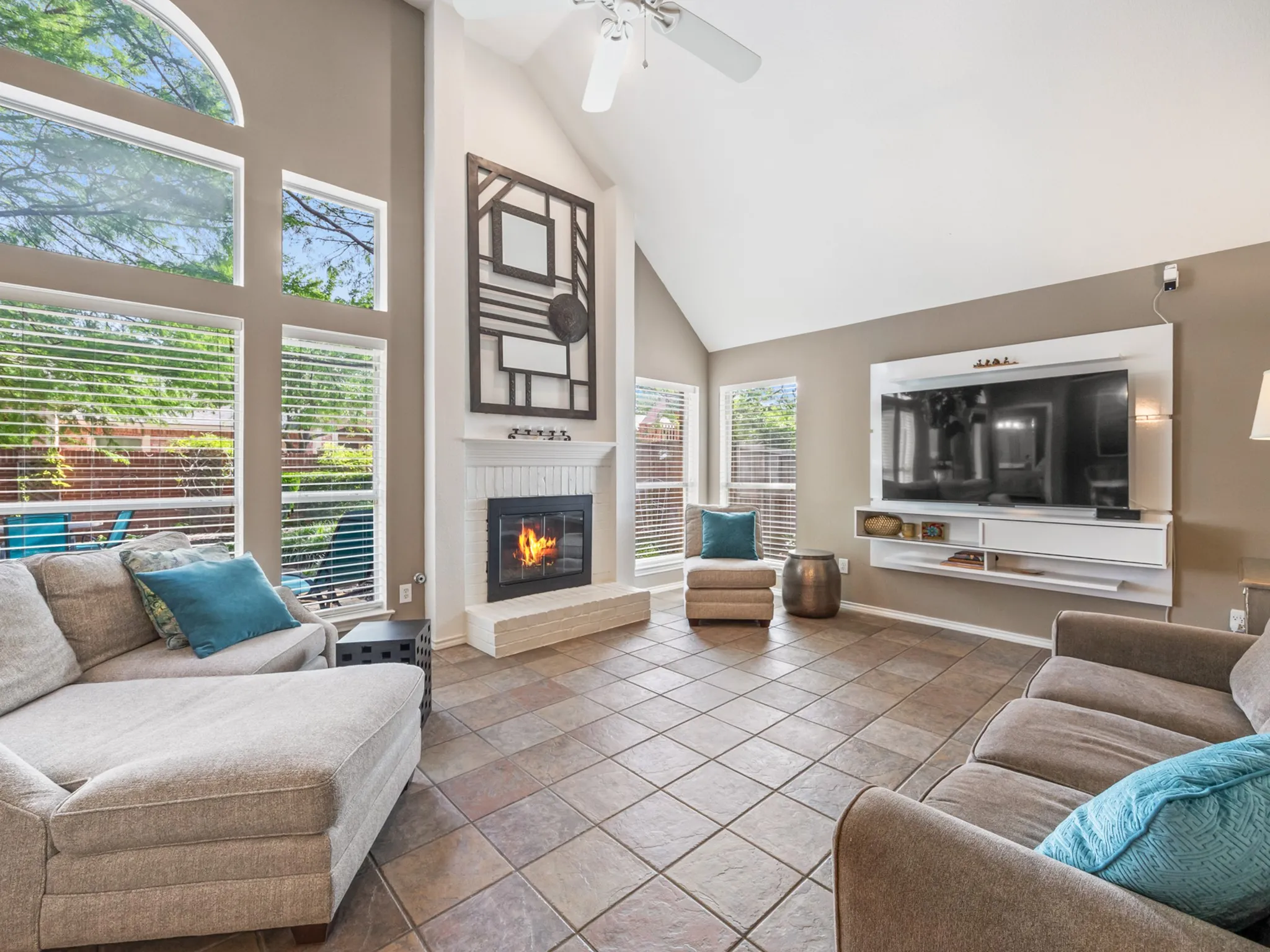 Living area featuring a vaulted ceiling and tile flooring