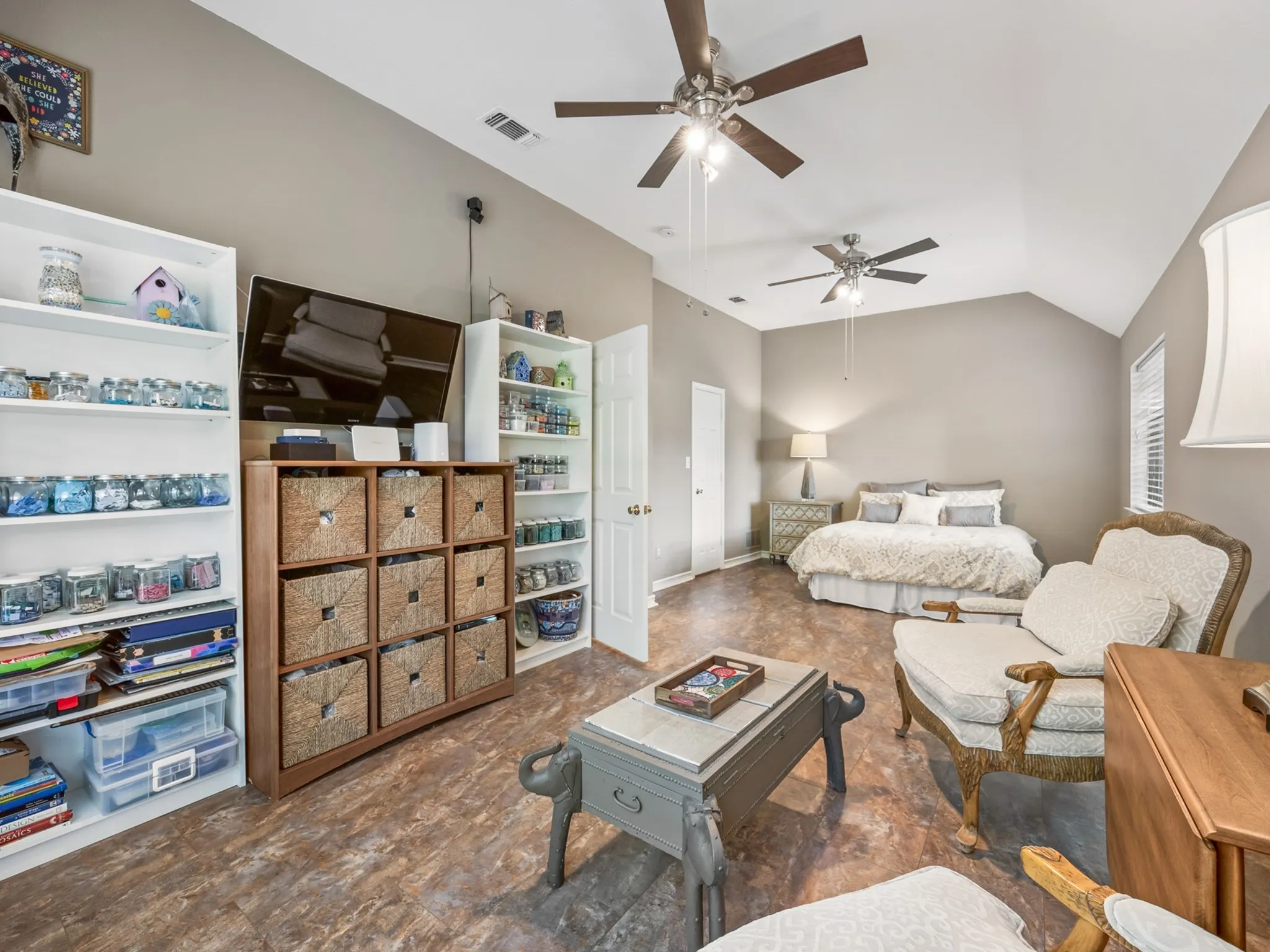 Spacious room with vaulted ceilings and wood-finish flooring