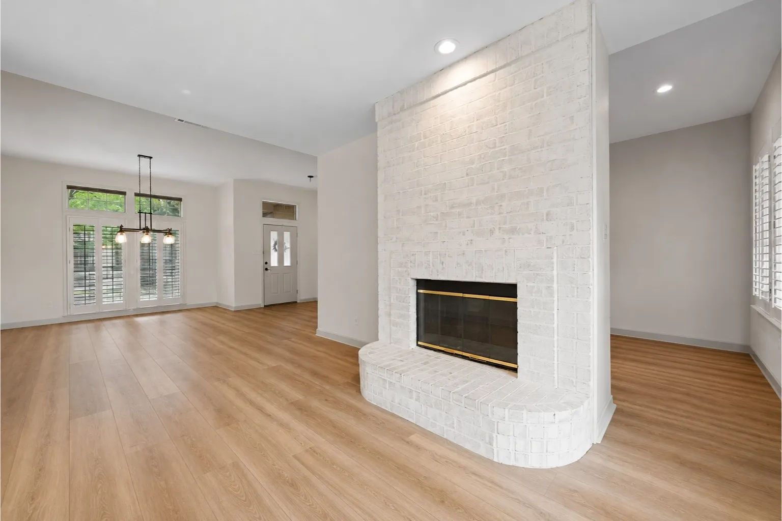 Central white-painted brick fireplace with a curved hearth