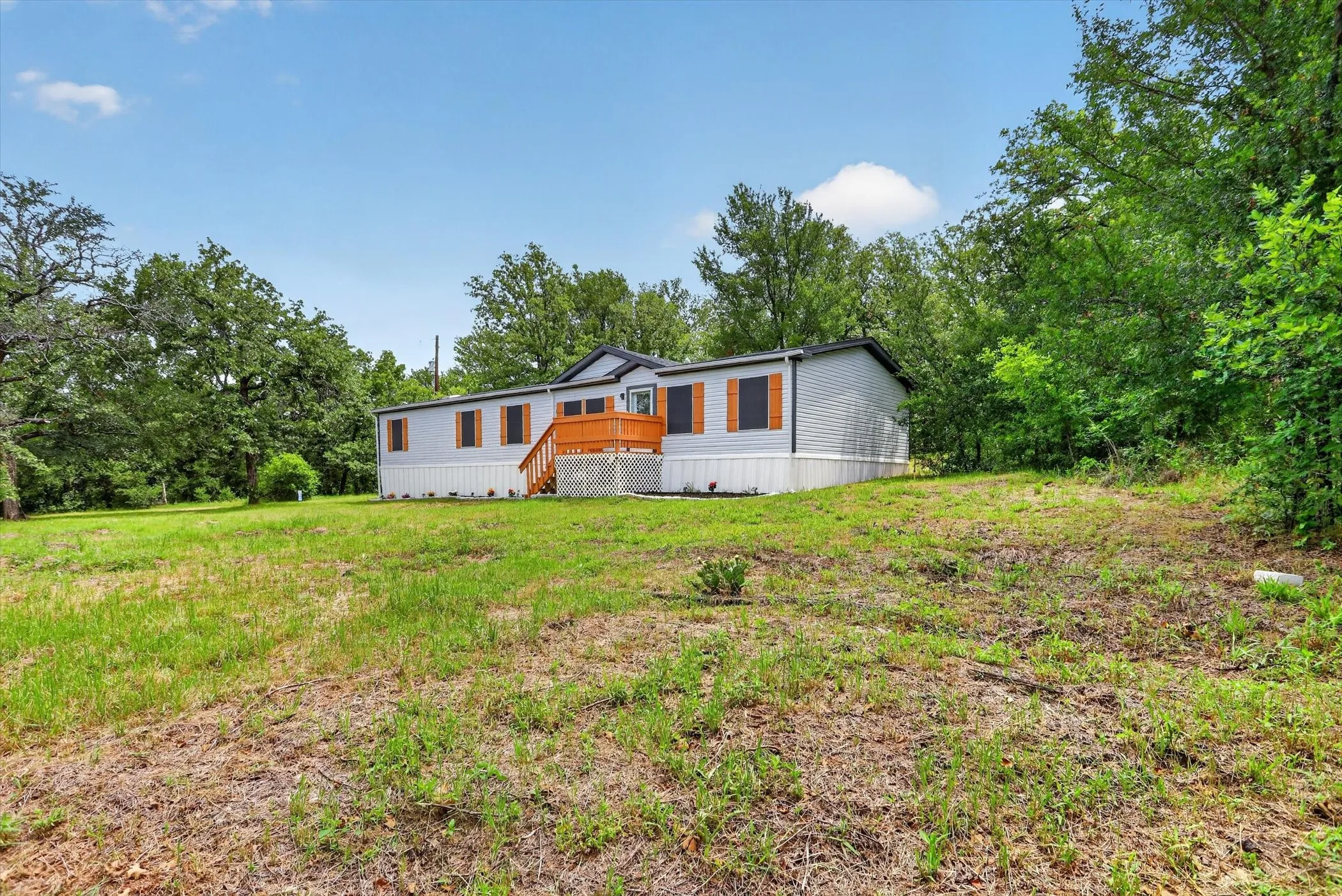 Gray siding exterior with contrasting dark trim and wood-toned shutters