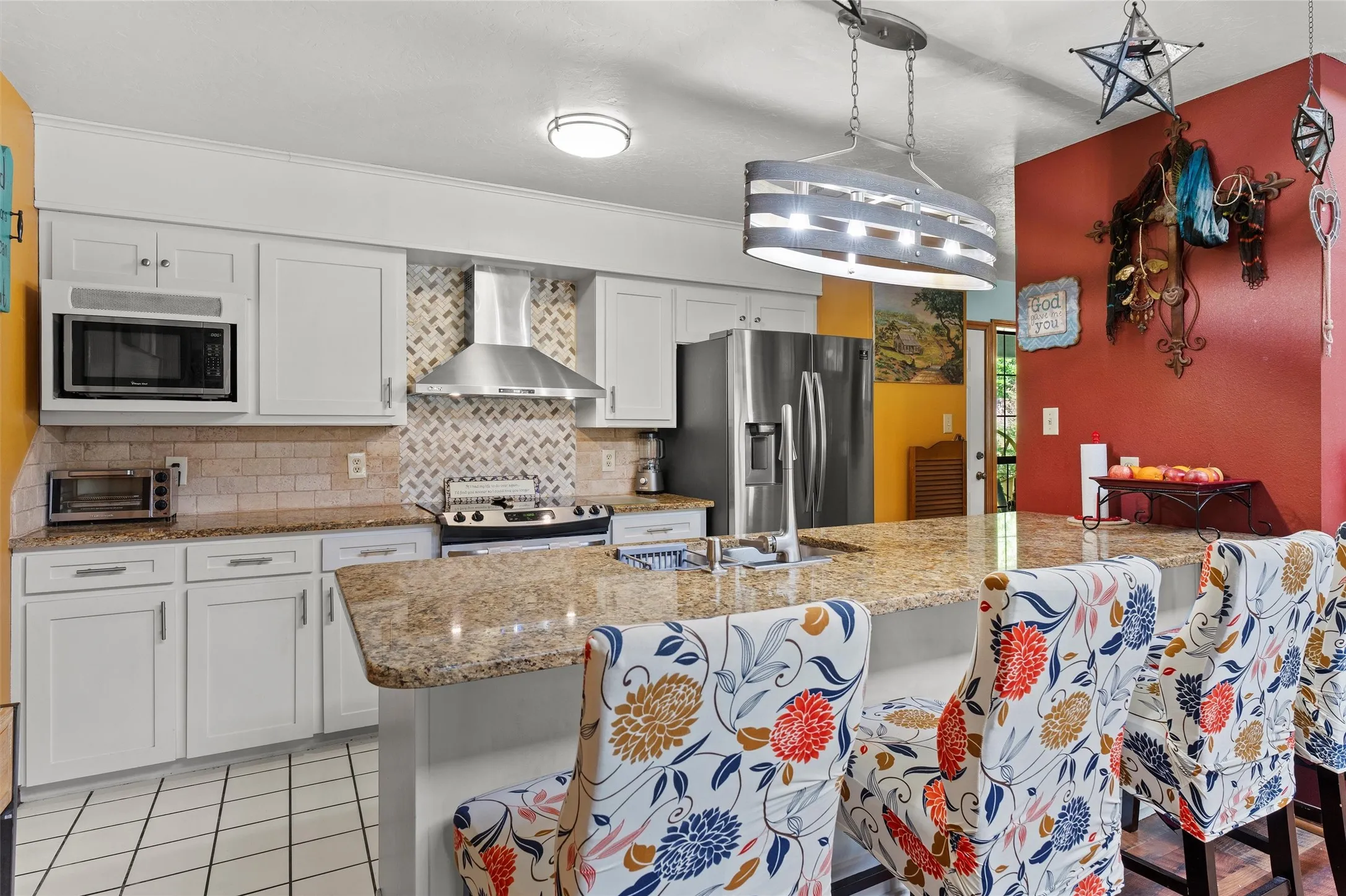 Kitchen featuring white cabinetry, light-toned granite countertops, and a tile backsplash