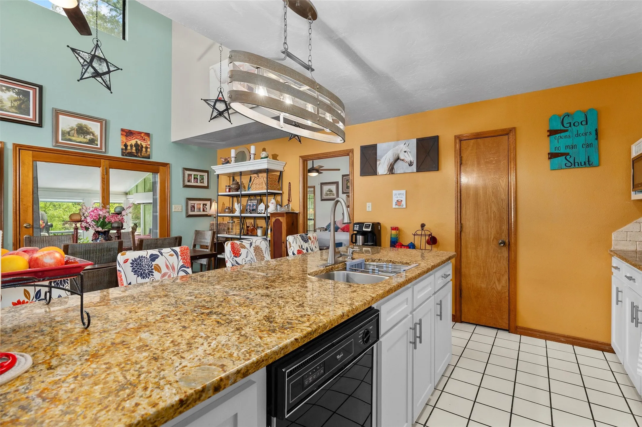 Kitchen with granite countertops and white cabinetry