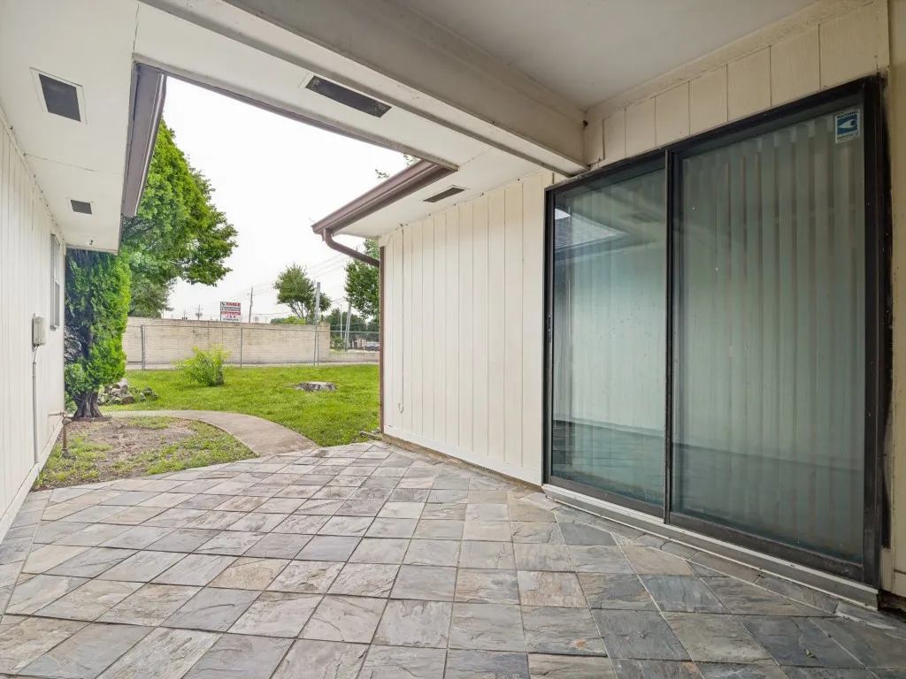 Patio with stone tile flooring and sliding glass door access