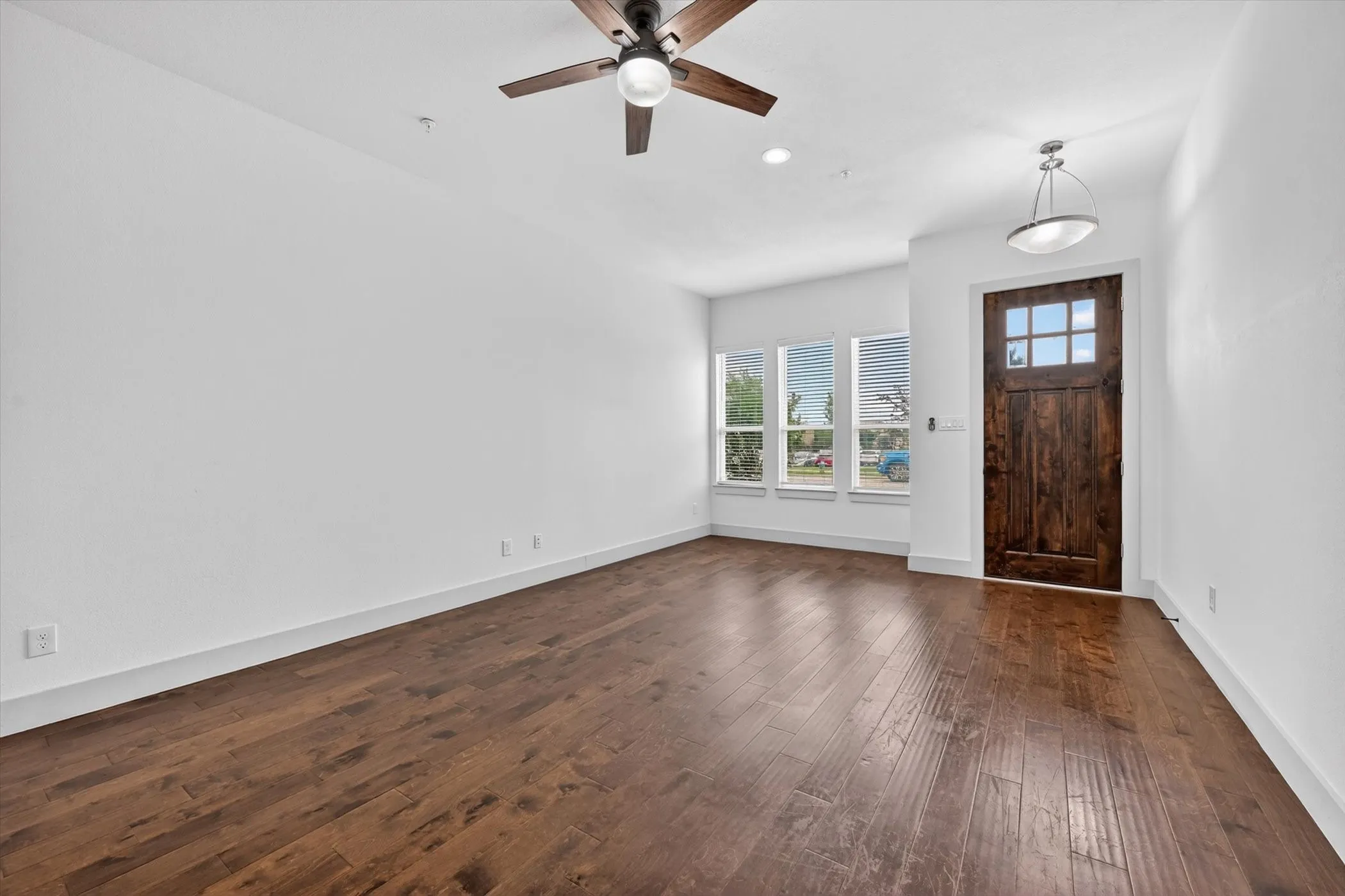 Spacious room featuring rich w white walls