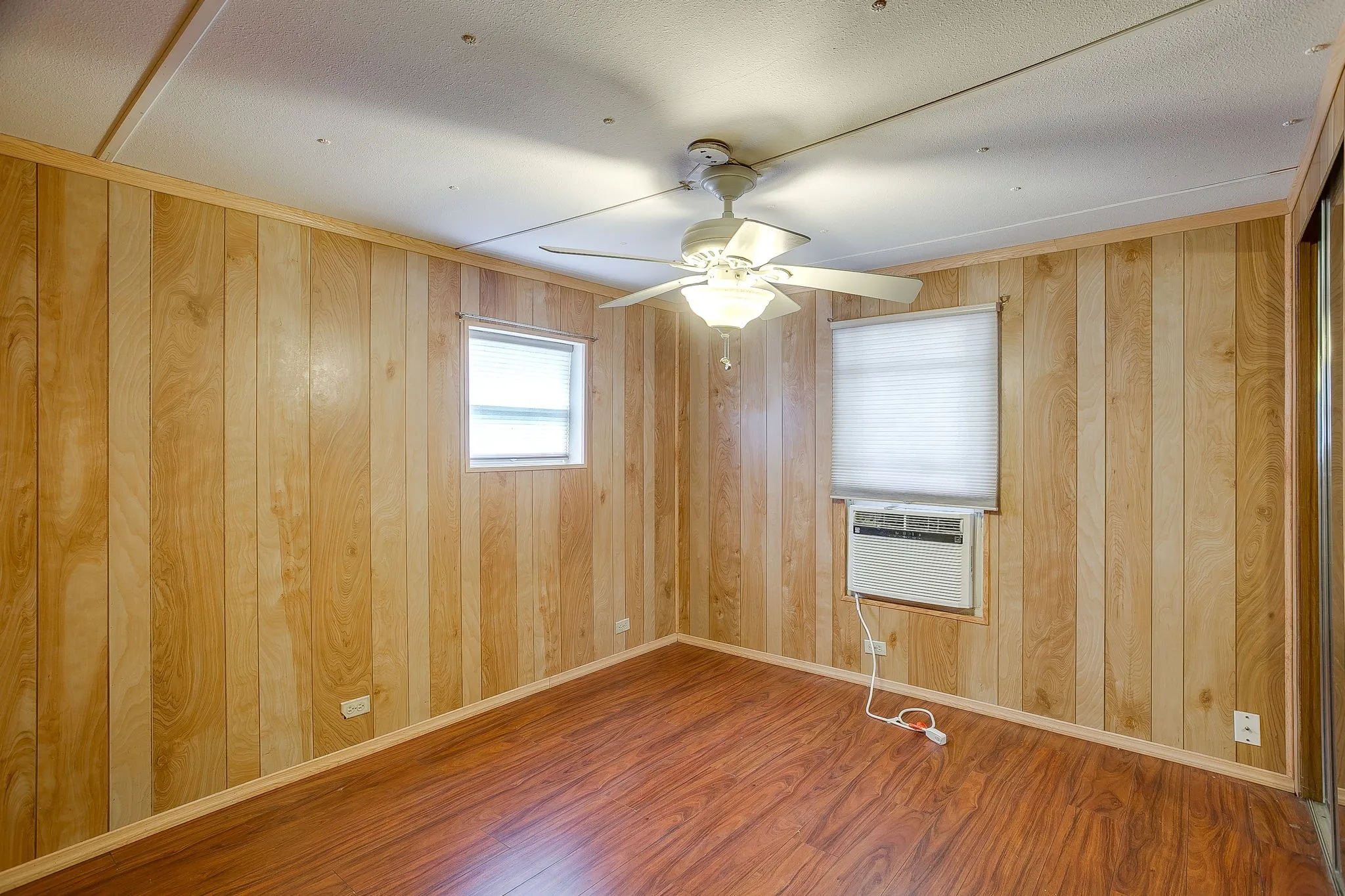 Room featuring wood-finish paneling walls and rich wood-finish flooring