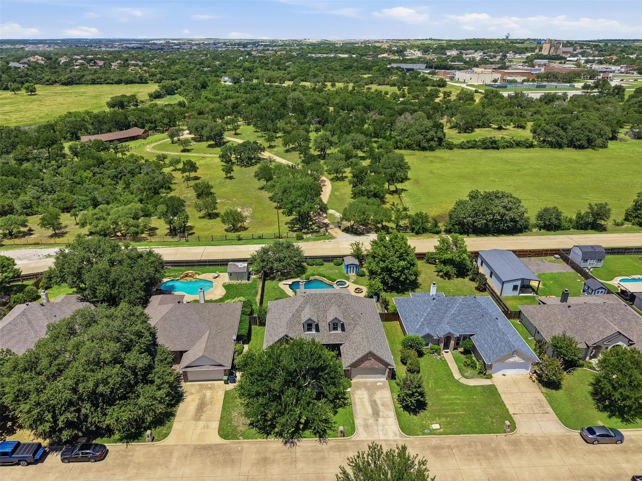 Aerial perspective showcasing a residential street with diverse home exteriors