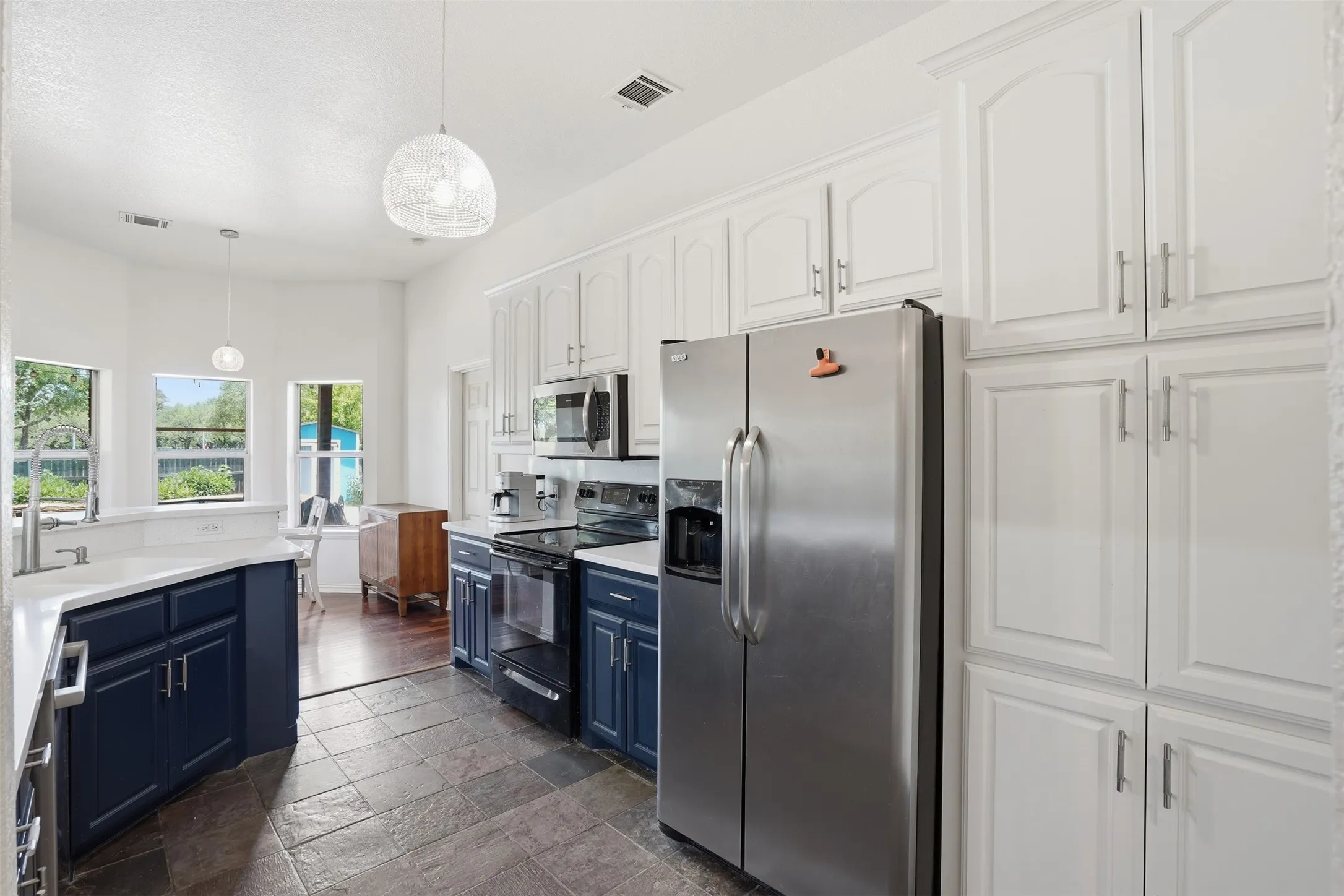 Kitchen featuring dark slate-style tile flooring and recessed lighting
