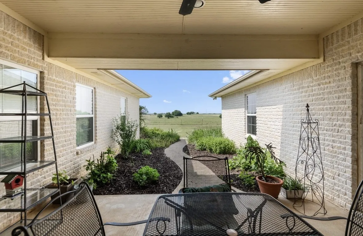 Covered patio with a concrete floor and beadboard ceiling