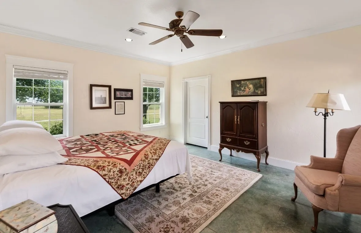 Spacious bedroom featuring multiple windows, a ceiling fan, crown molding, a recessed light, and durable flooring